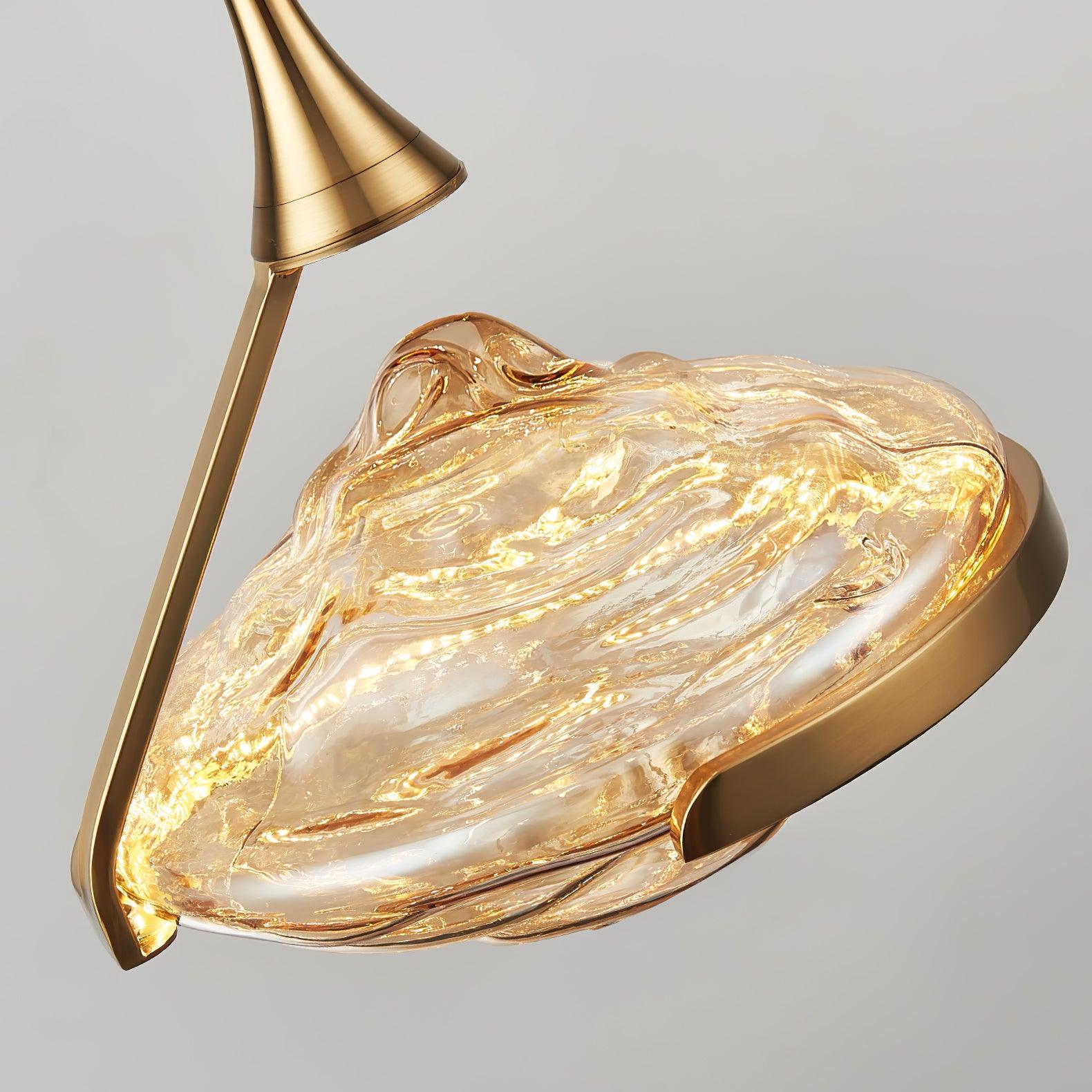 Angled close-up of gold-toned flared head and diagonal support around illuminated rippled glass