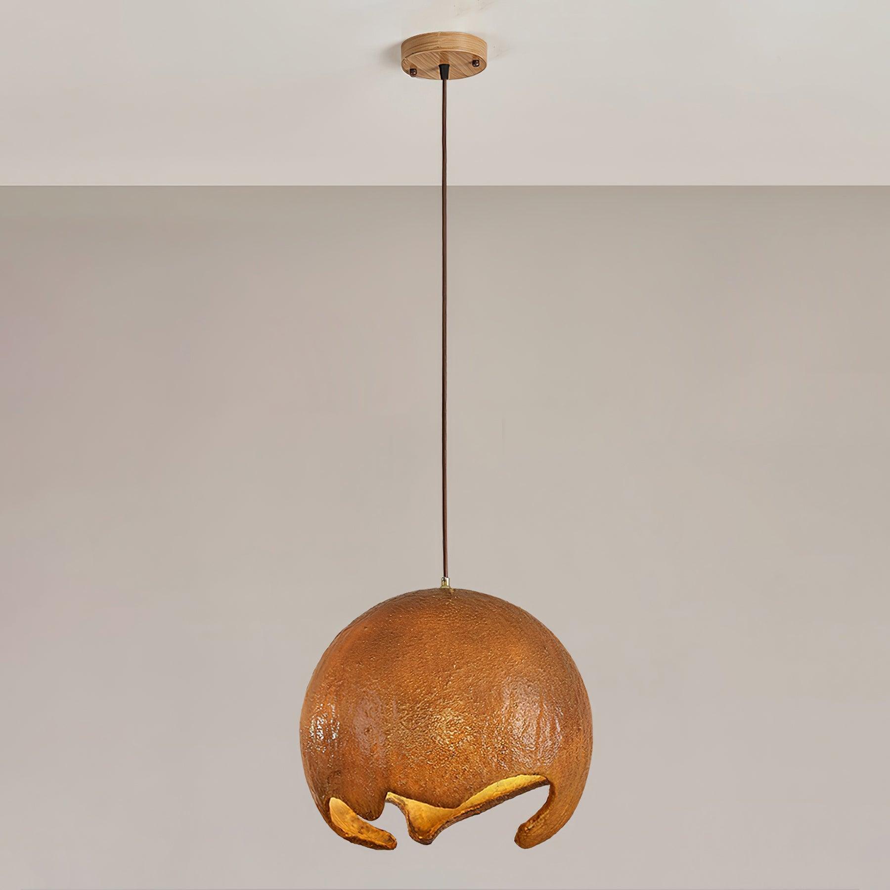 Large brown globe pendant below a gold-coloured canopy