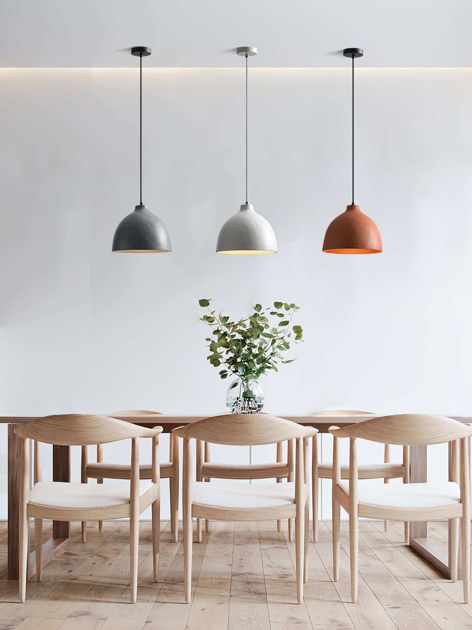 Three coloured pendants above a wooden table