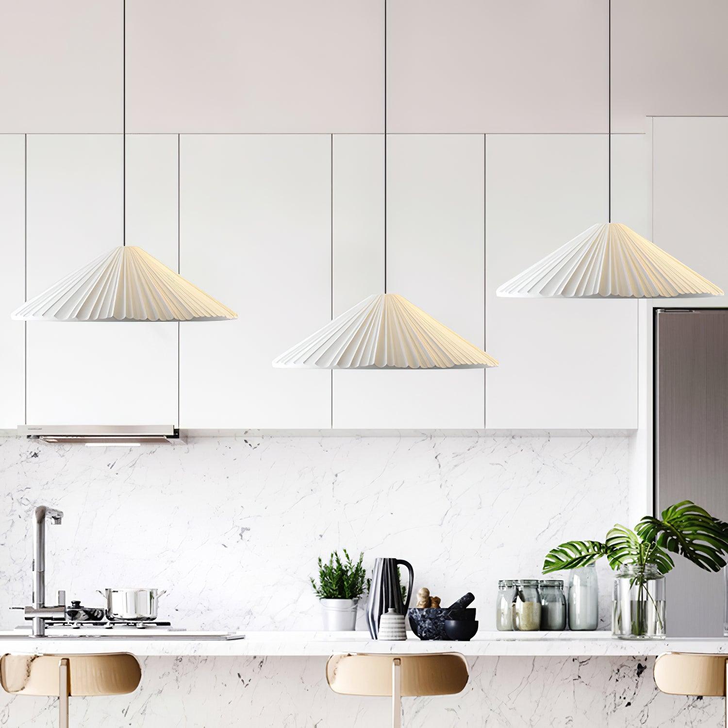 White pleated pendants above a kitchen counter