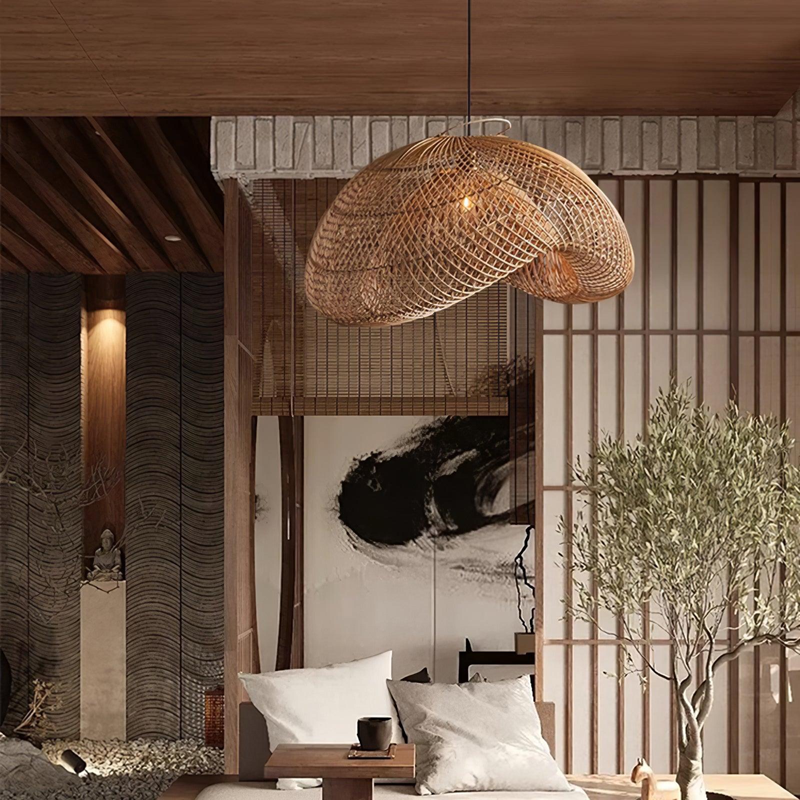 Close seating-area view with woven wave pendant, white cushions, tea cup, tree and large brushstroke artwork