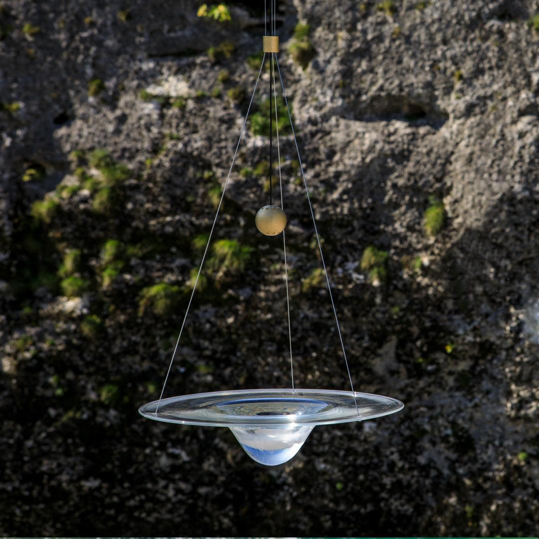 Clear glass disc and droplet centre in a water-side scene