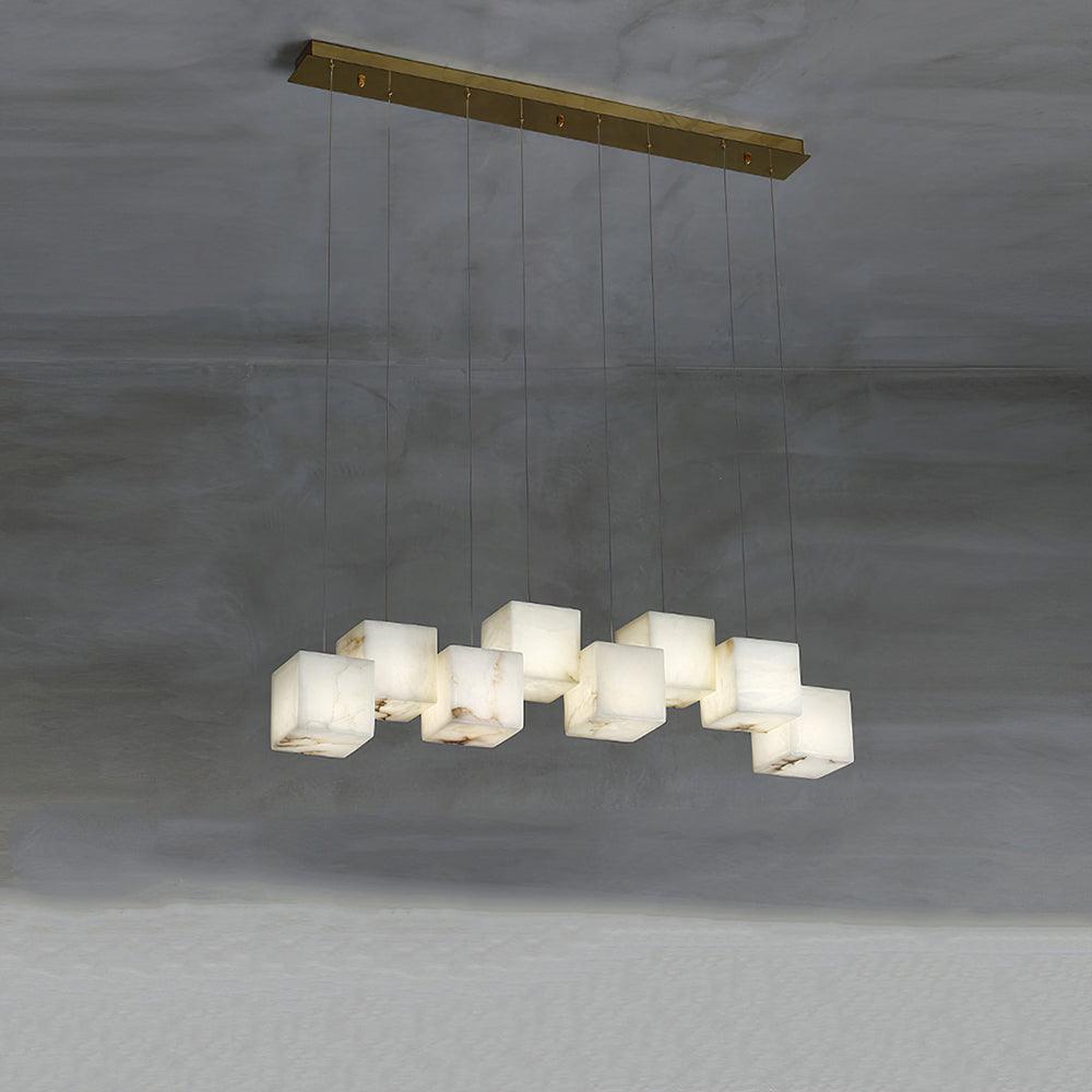 Eight white cube shades on individual cables below a long gold canopy