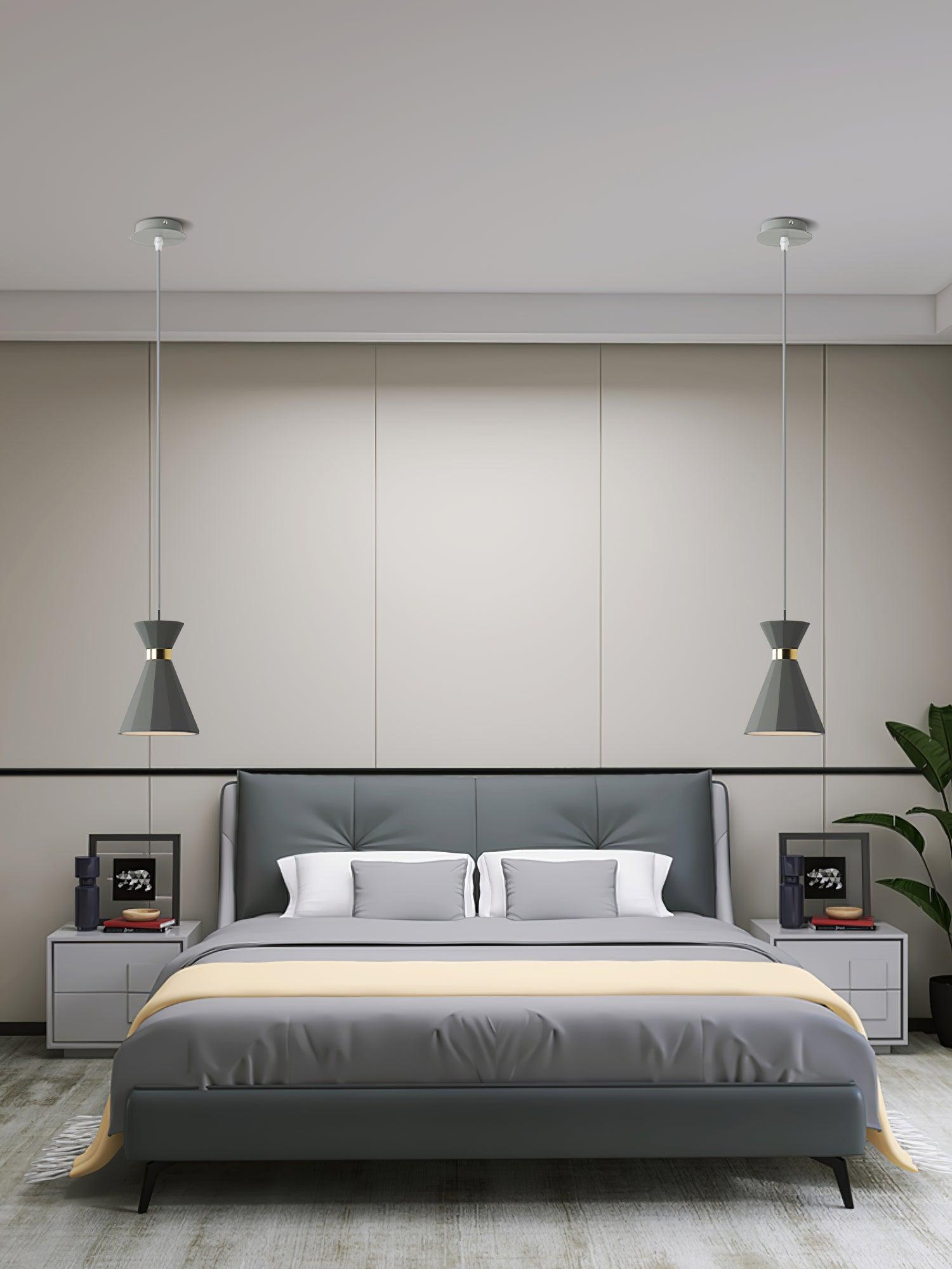 Pendant lighting on opposite sides of a bed