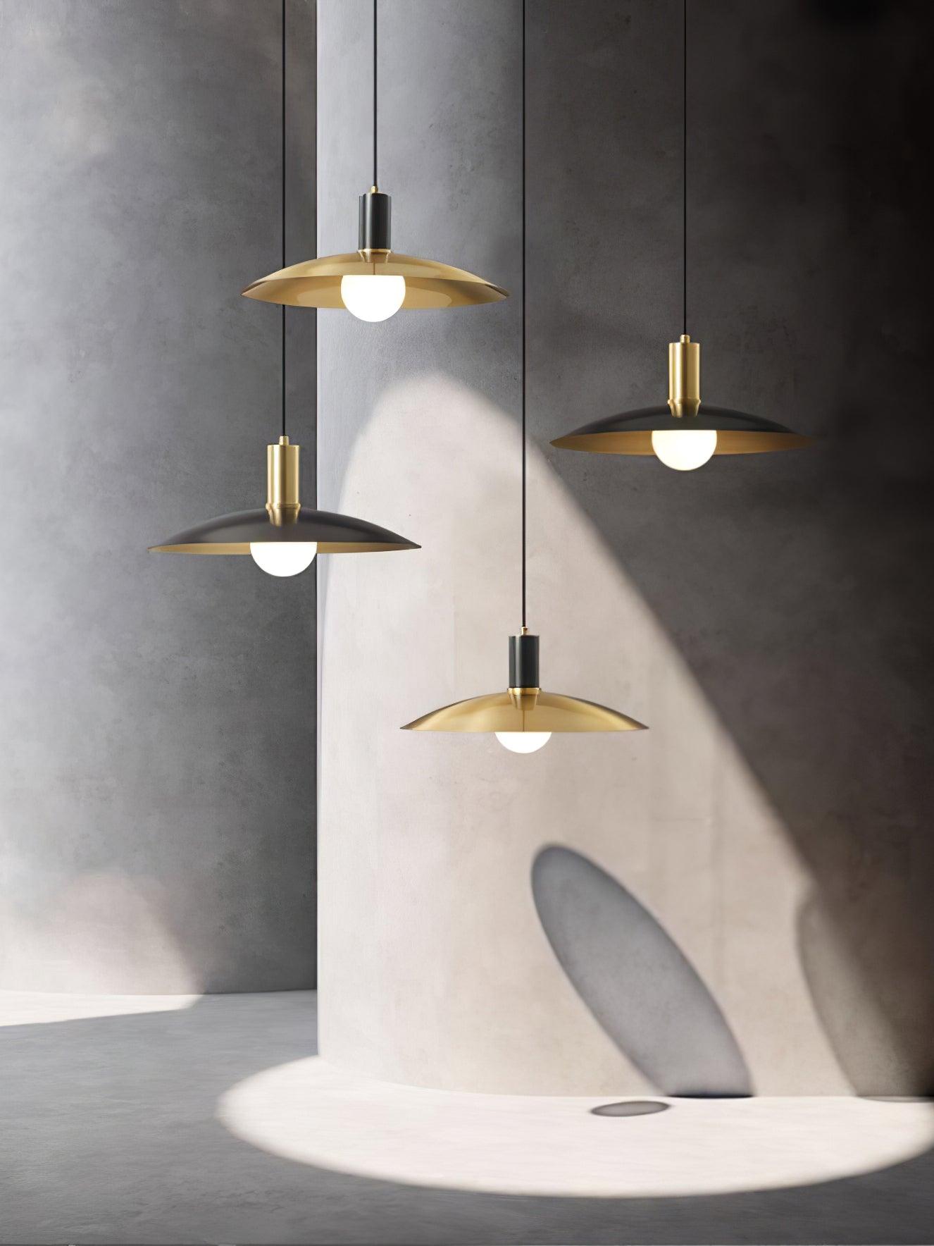 Mixed brass and black flared pendants arranged at different heights