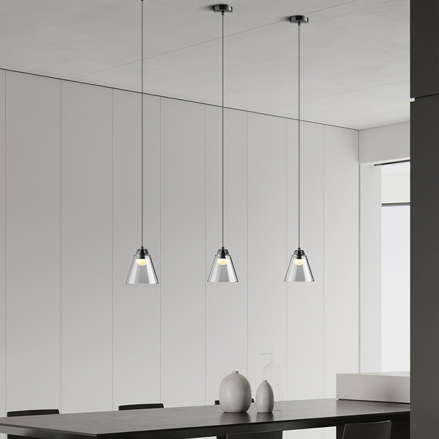 Three glass cones with separate ceiling points above a table