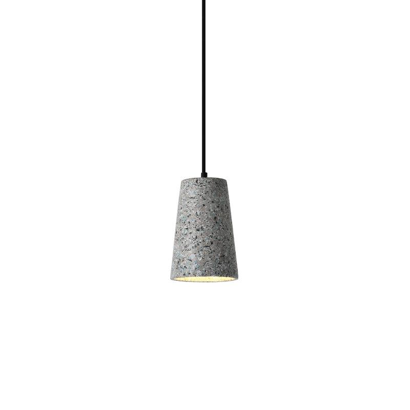 Tall tapered grey cement shade hanging from a black cord