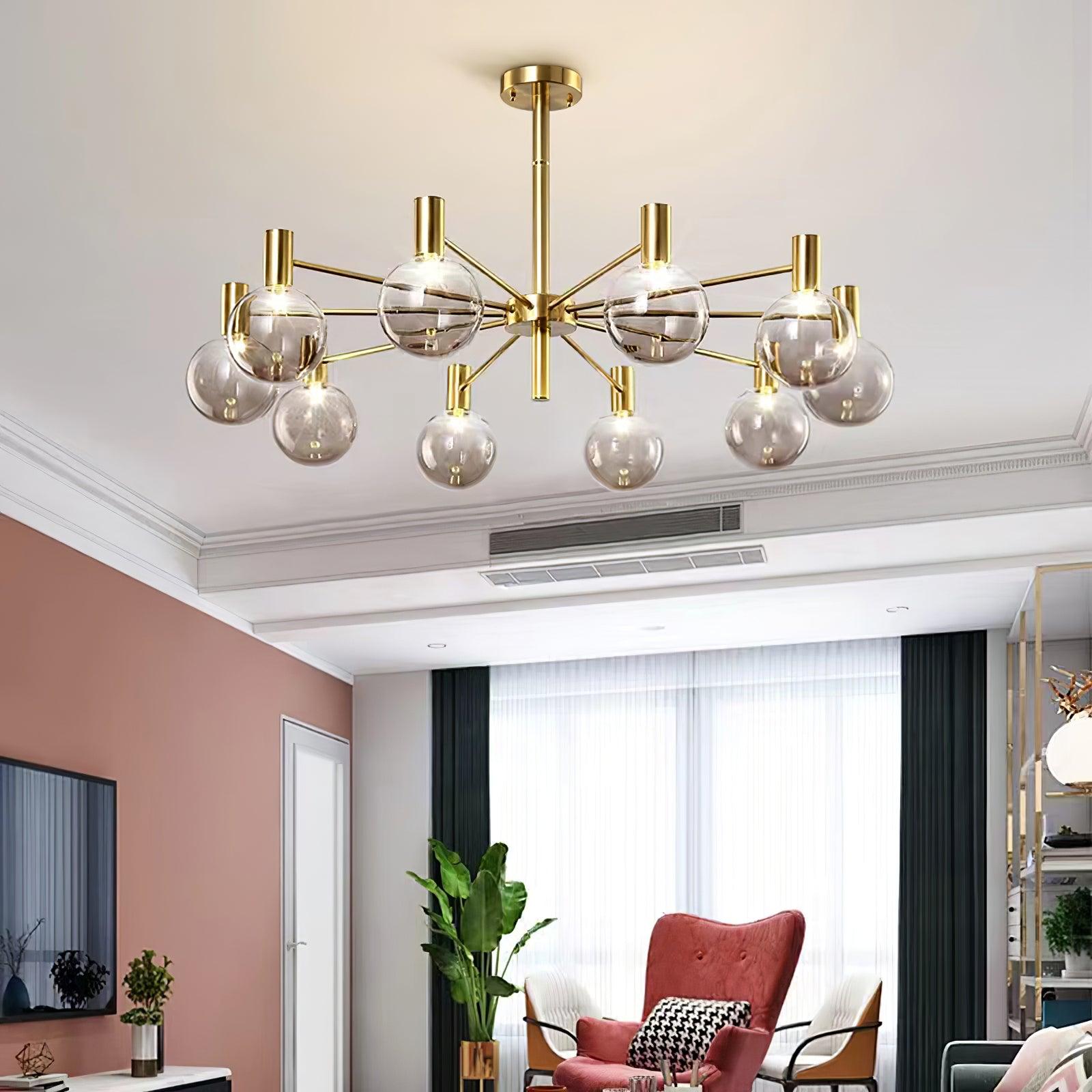 Clear-globe chandelier in a lounge with a pink wall, red wingback chair, television, leafy plant and metal shelving.