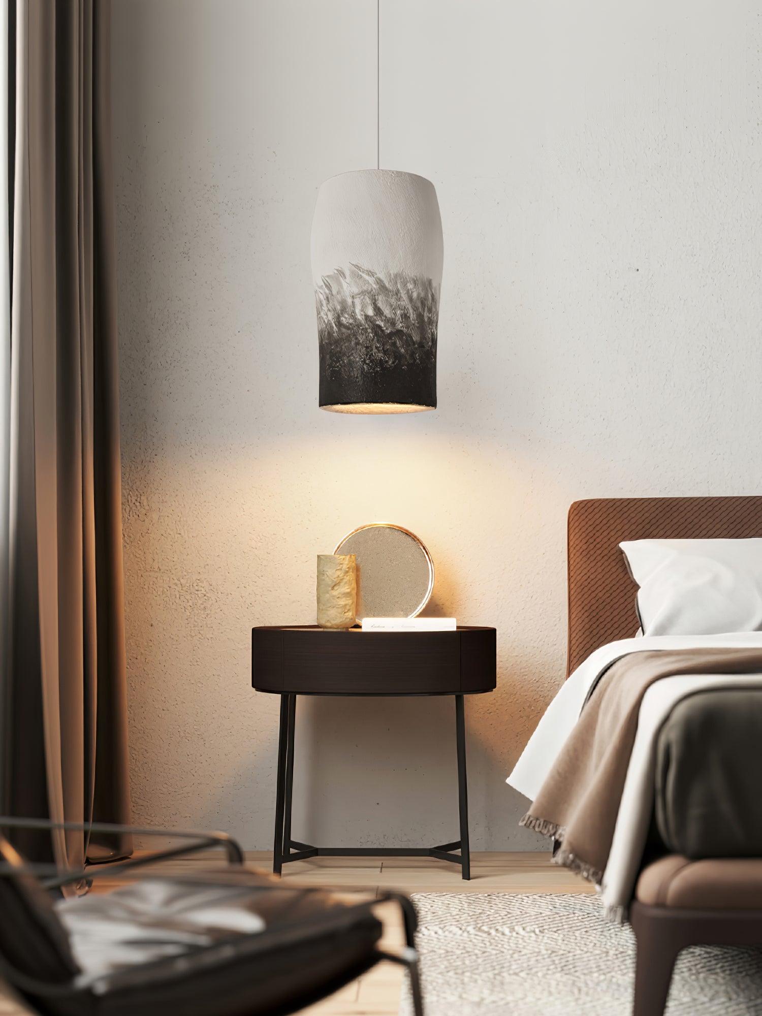 Textured bedside pendant over a dark side table