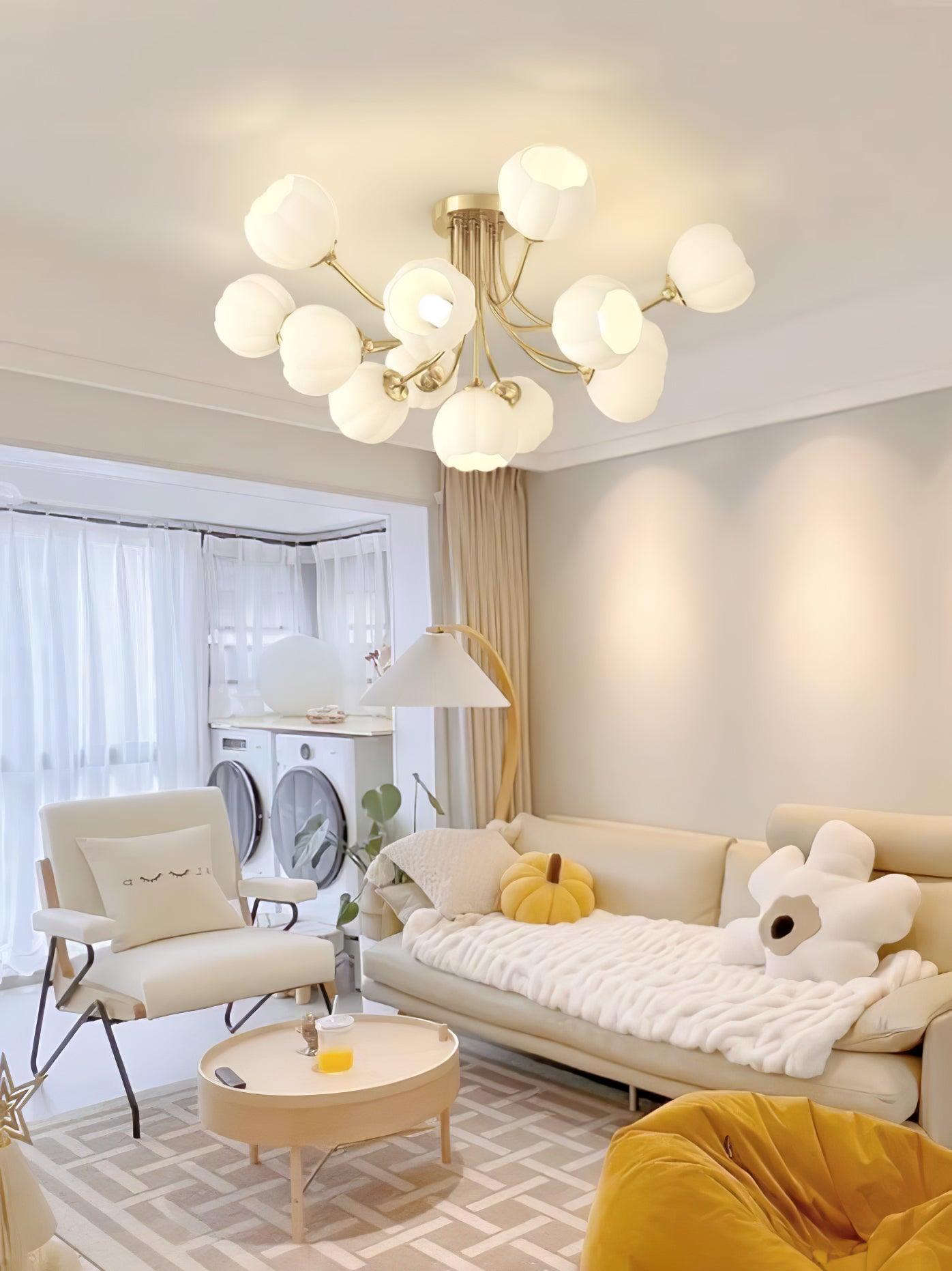 Brass-colour Pumpkin ceiling light with white shades above cream seating and yellow cushions