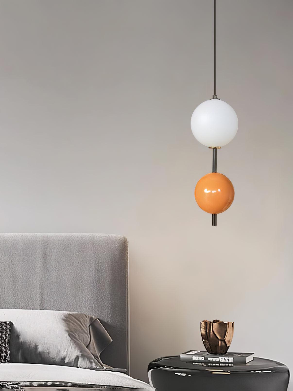 Orange two-ball pendant above a side table