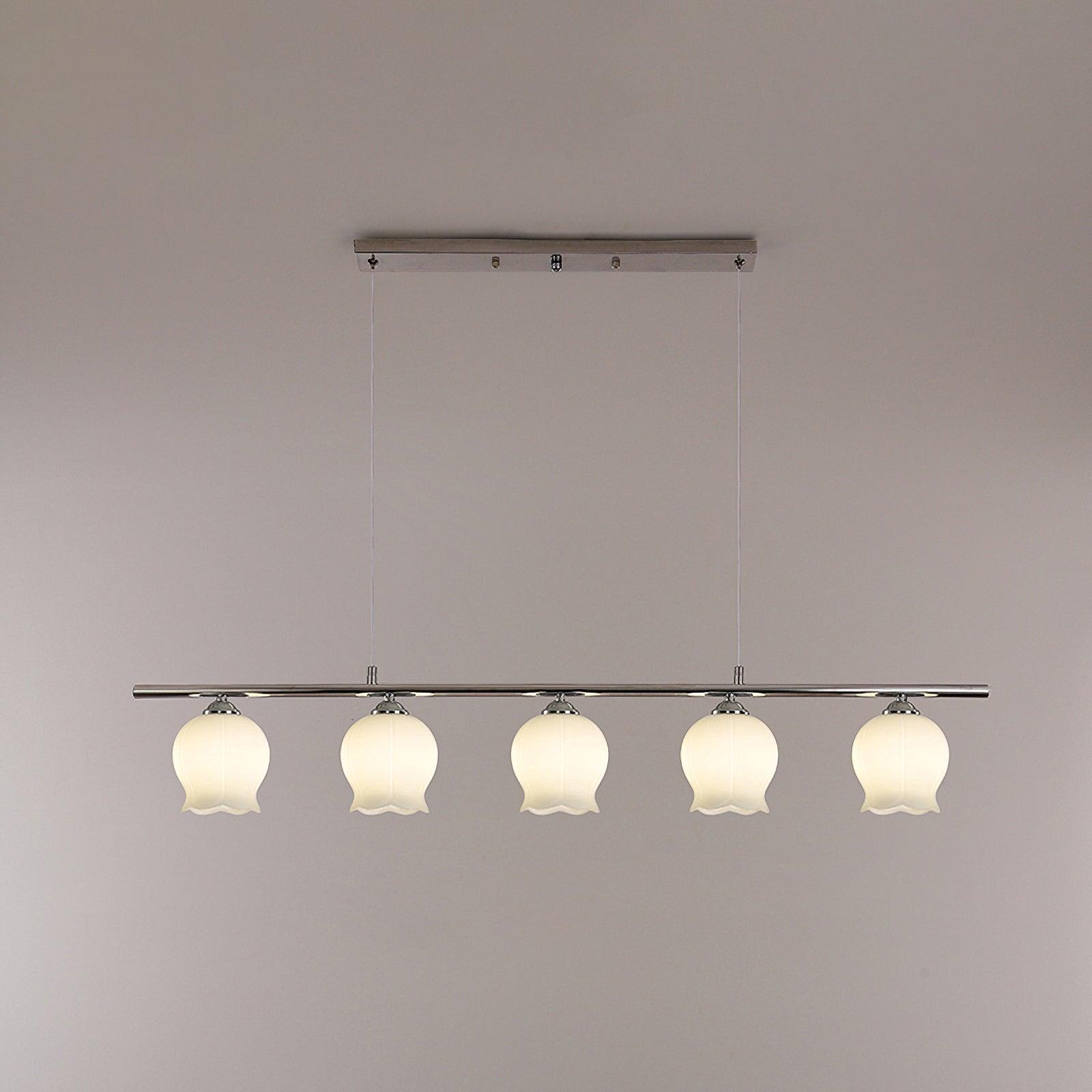 Illuminated five-shade linear chrome pendant with white bellflower glass
