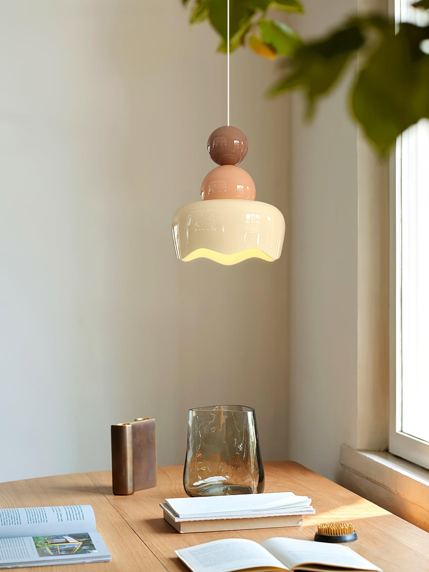 Small doll-form pendant above a desk