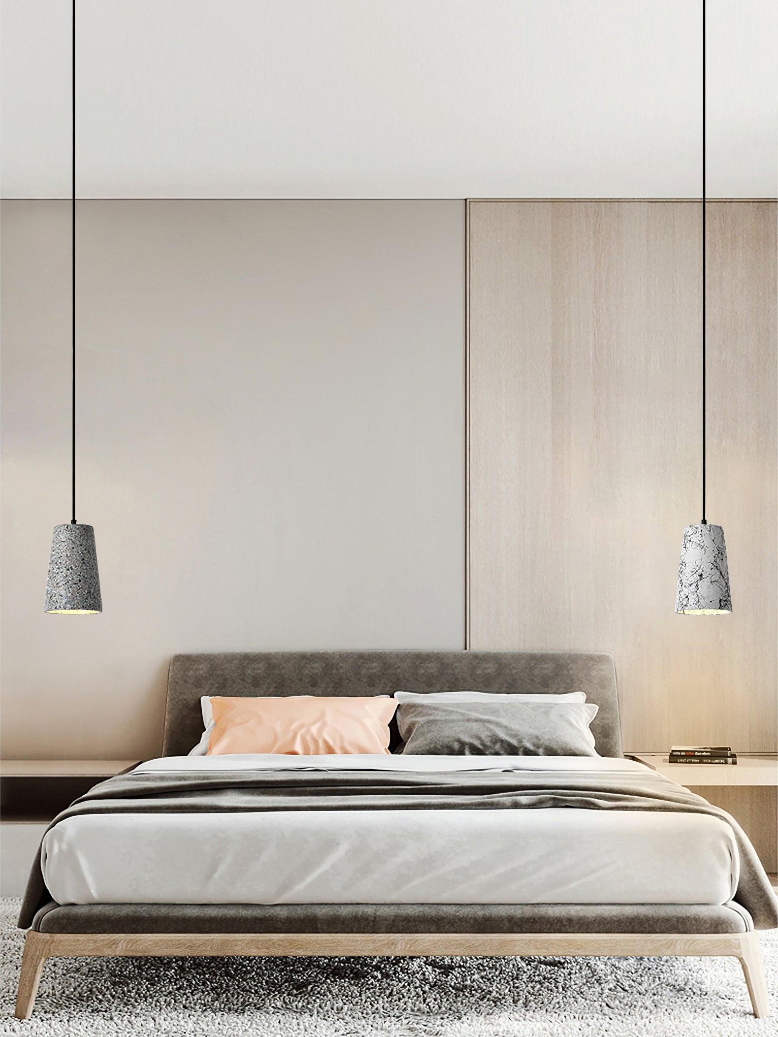 Two tapered Hubble pendants flanking a bed