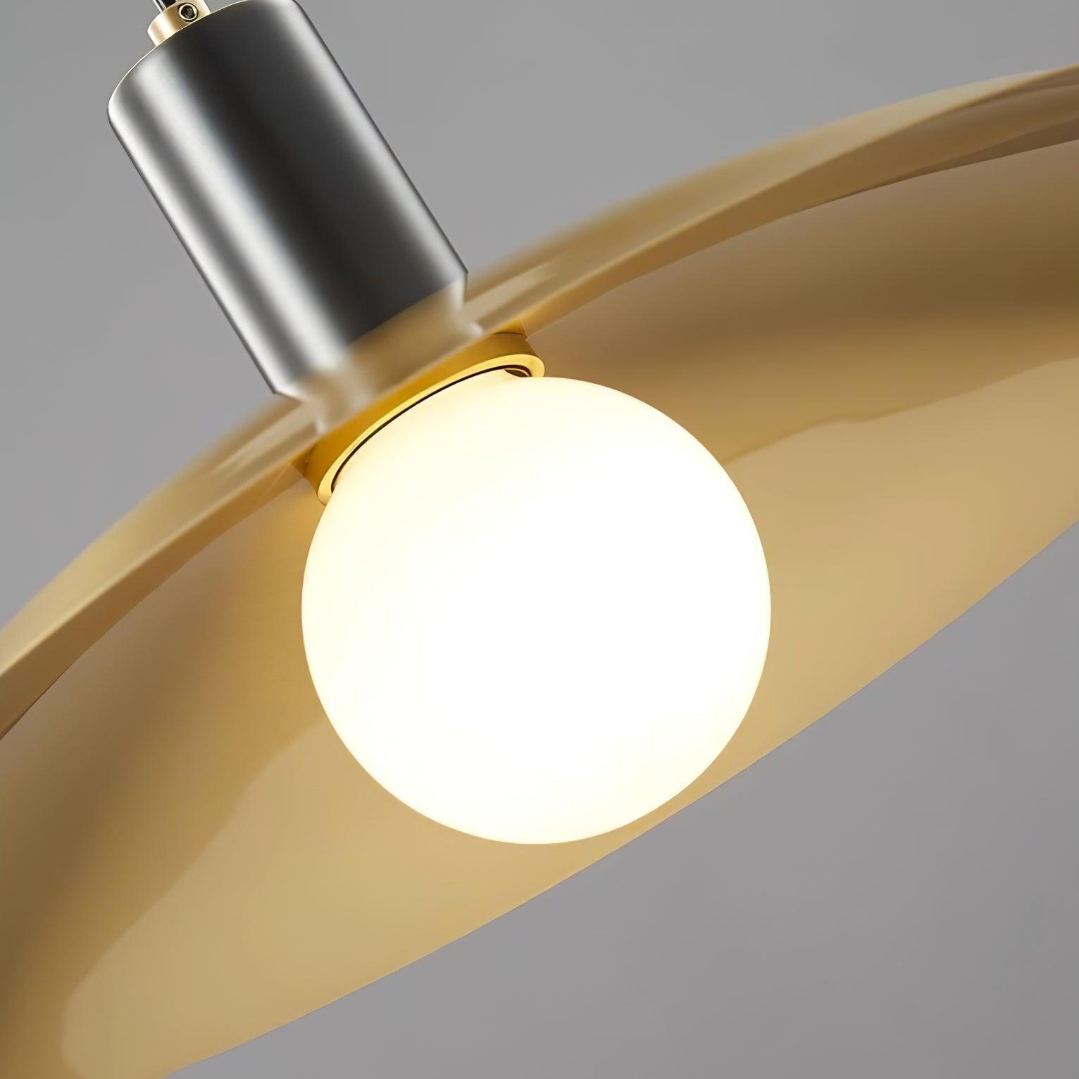 White globe beneath a brass-colour shade and black cylindrical fitting