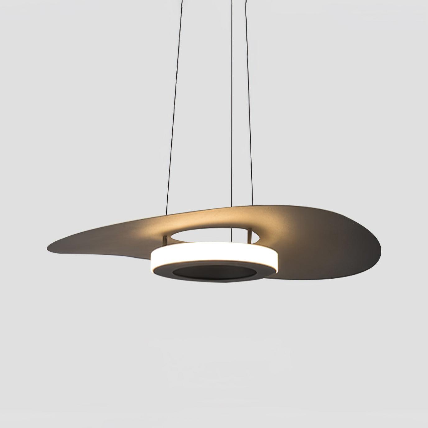 Dark sculpted disc shade with warm reflection across raised rim and luminous ring below, pale background