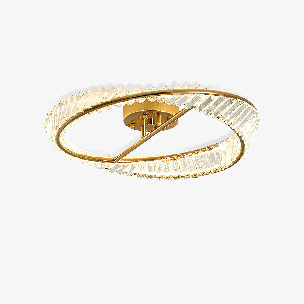 Isolated illuminated Crystal Rings ceiling light with clear glass and a gold-tone frame on white