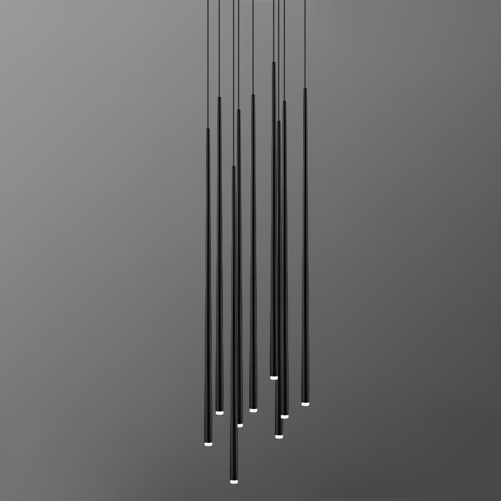 Staggered black tube pendant cluster on grey, showing white end caps and suspension cables