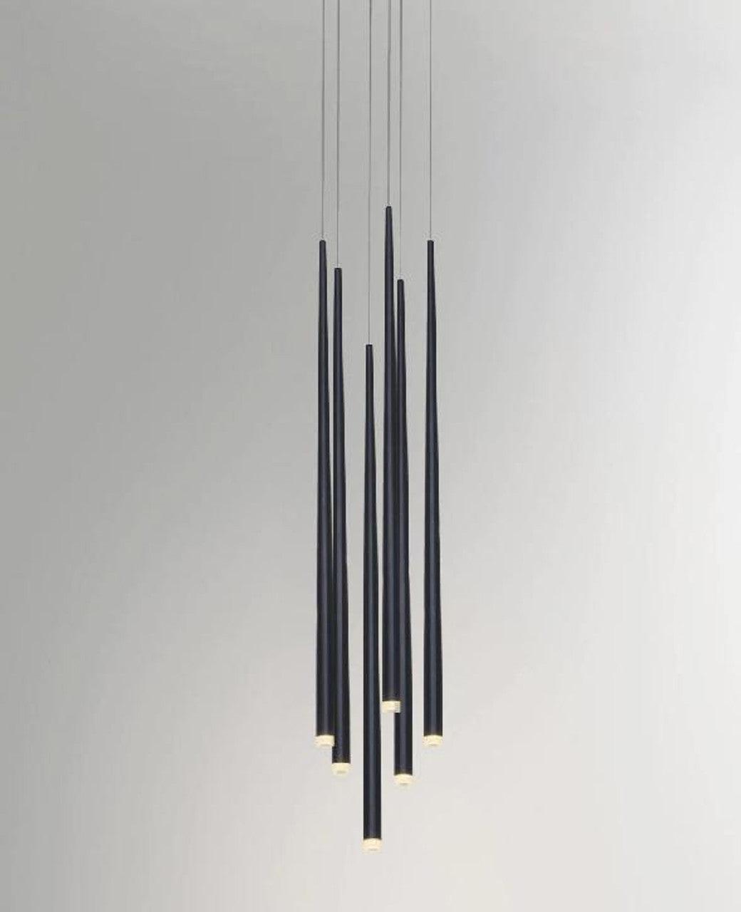 Six staggered black tube pendants on pale grey with illuminated circular ends
