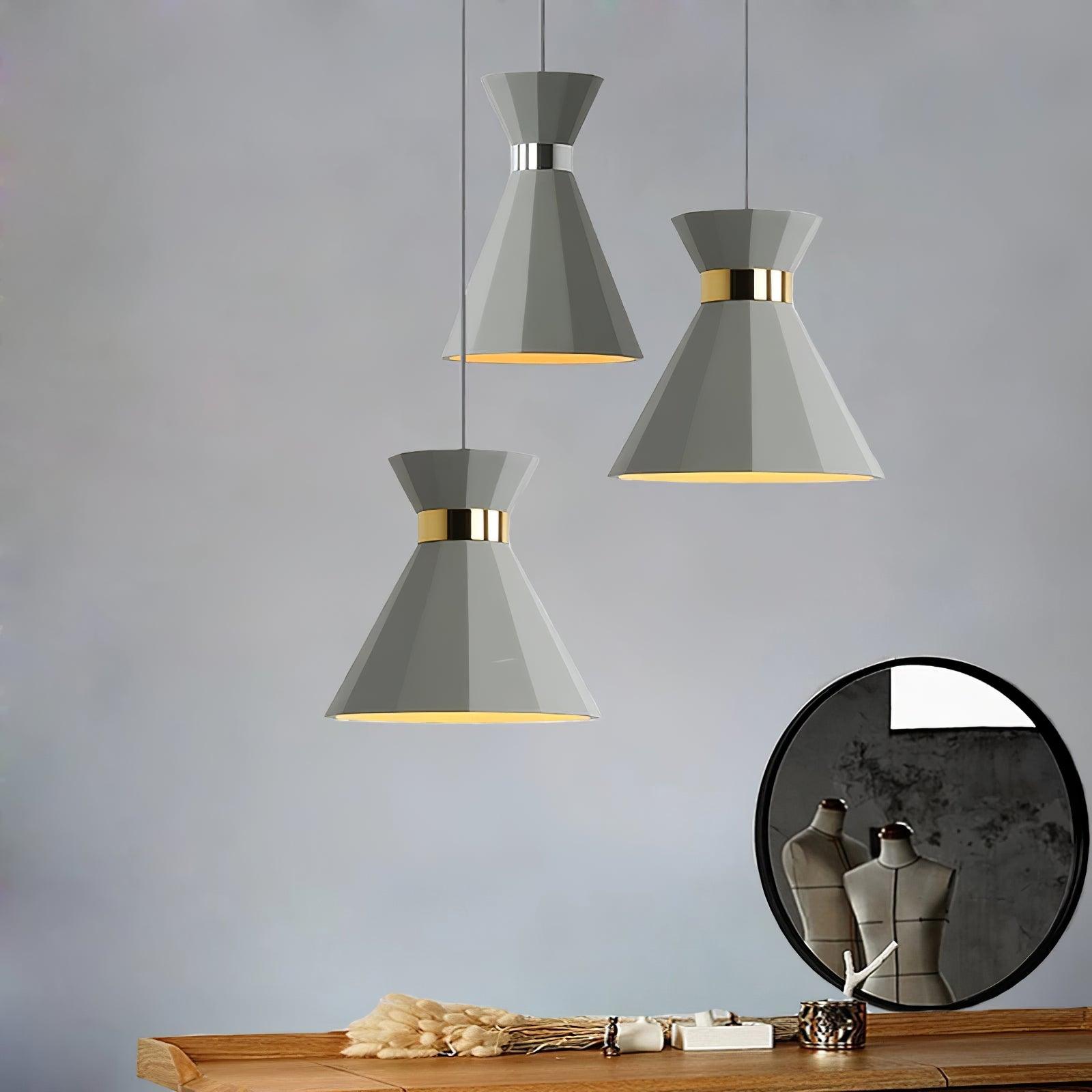 Grey and gold pendants grouped above a console