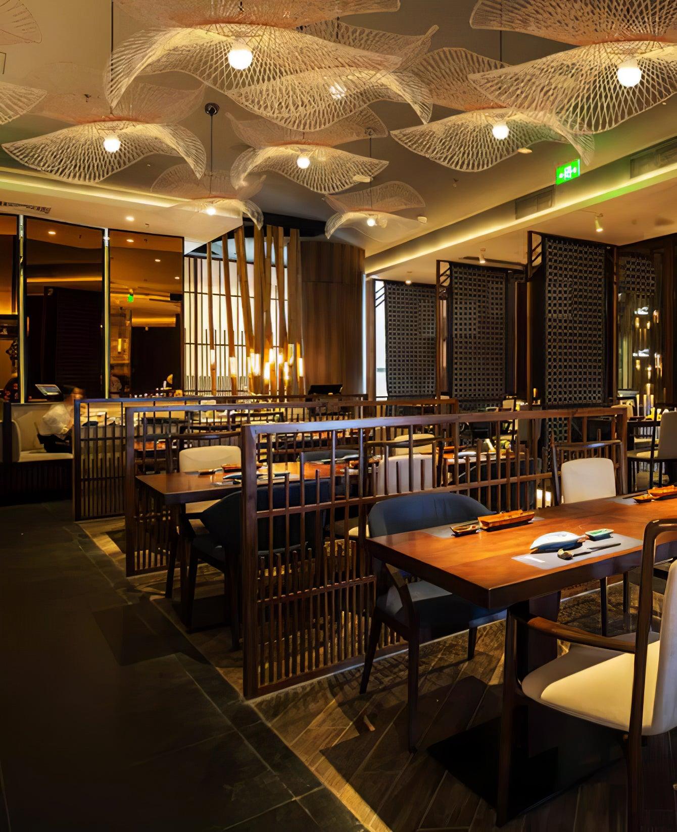 Repeated bamboo shades above restaurant tables