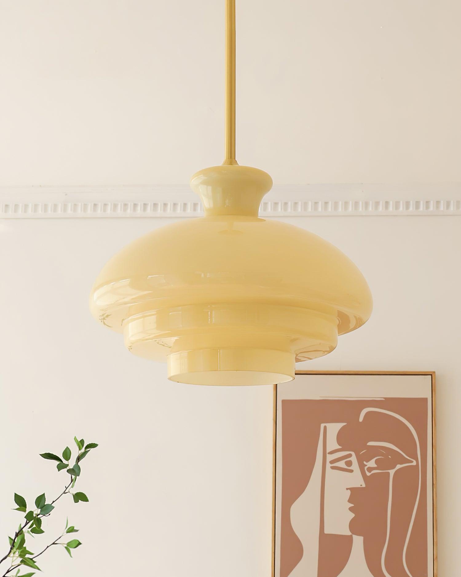 Closer pale-yellow dome showing glossy reflections and stepped edges beside framed artwork
