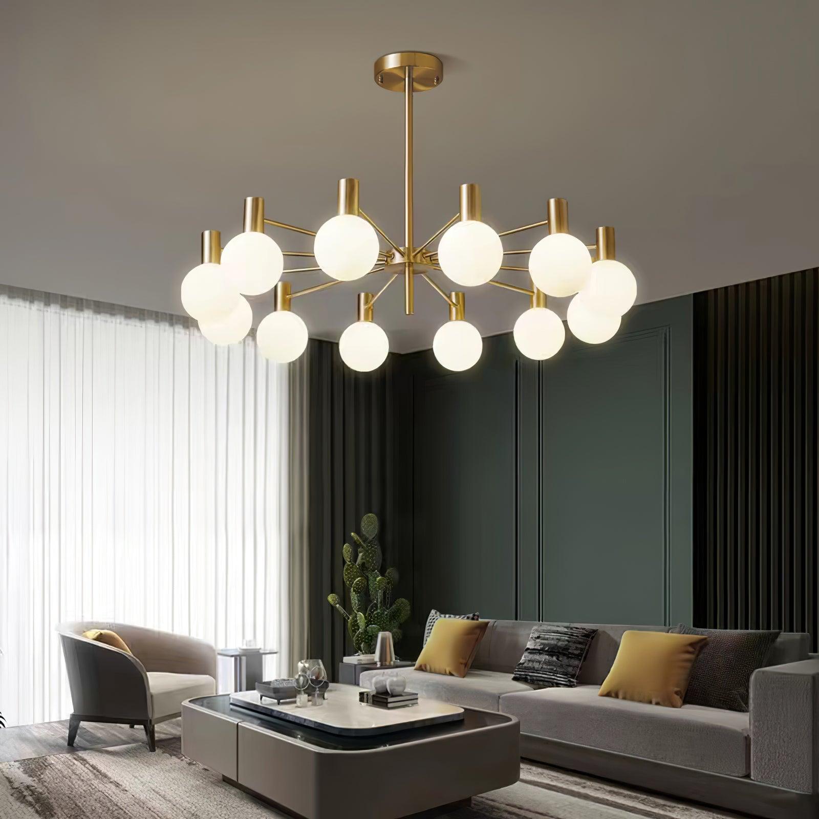 White-globe chandelier above a grey sofa with mustard cushions and a layered coffee table in a teal-panelled lounge.