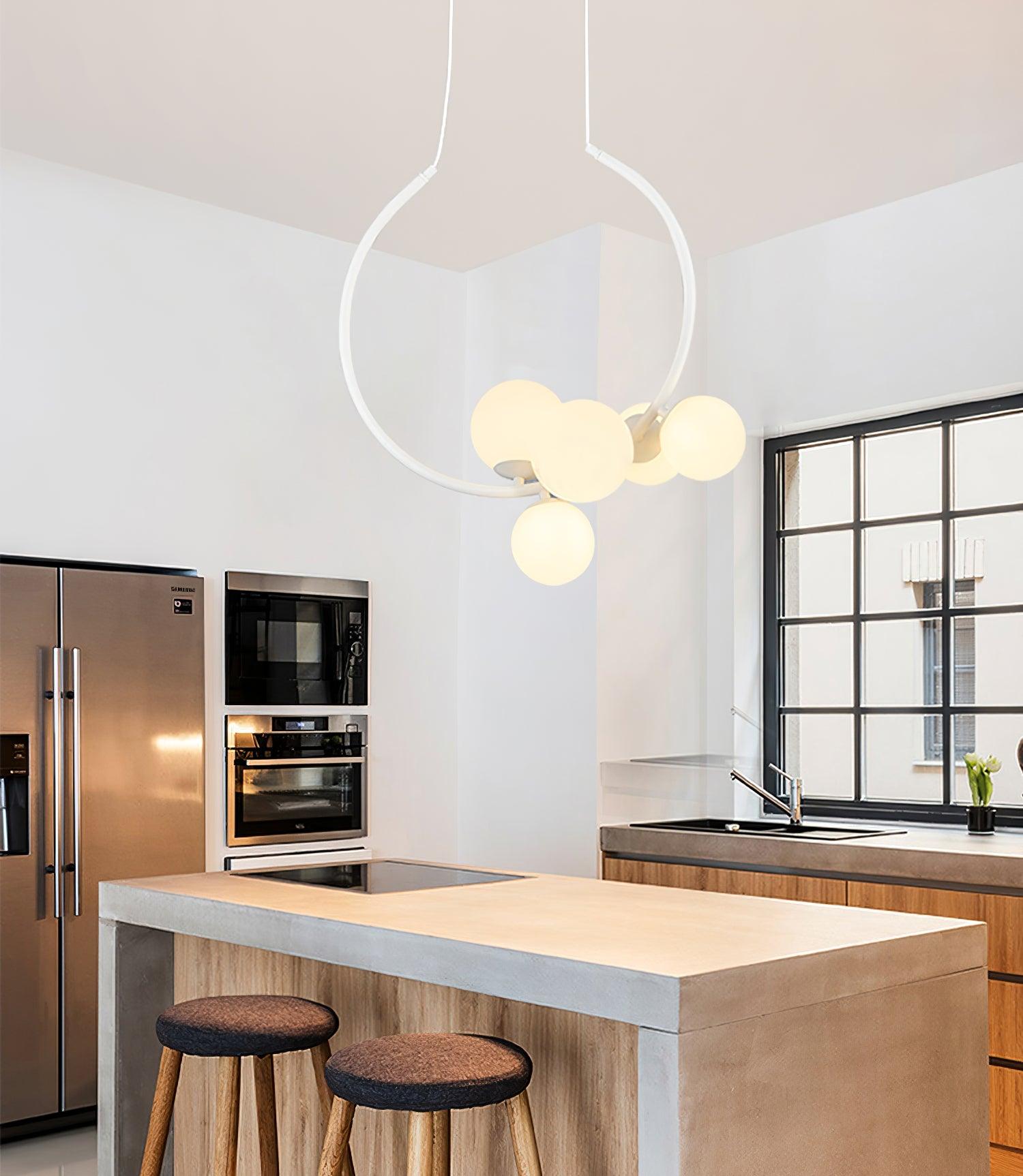 White circular pendant above a kitchen island