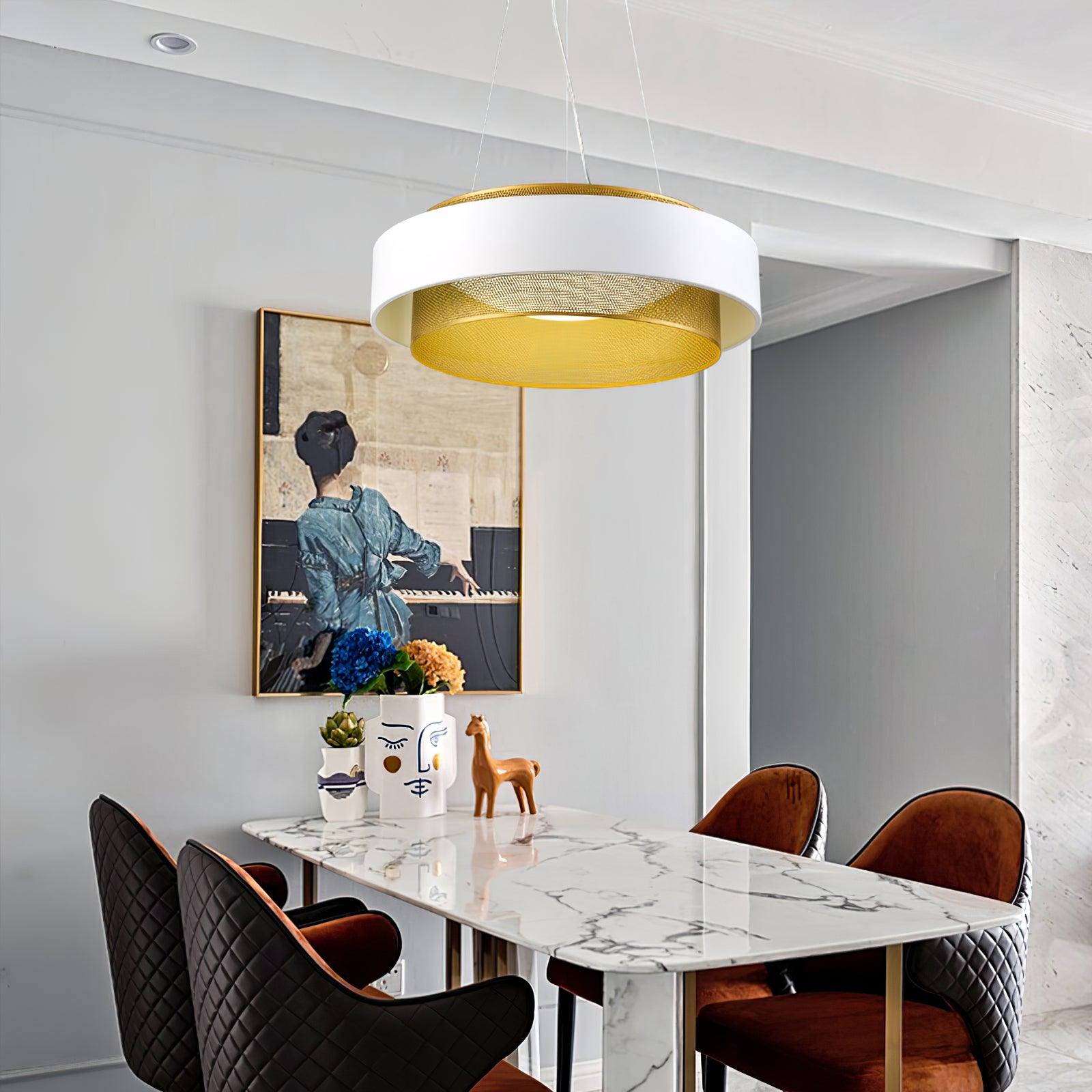 White and gold-tone perforated pendant above a marble-pattern dining table with brown chairs