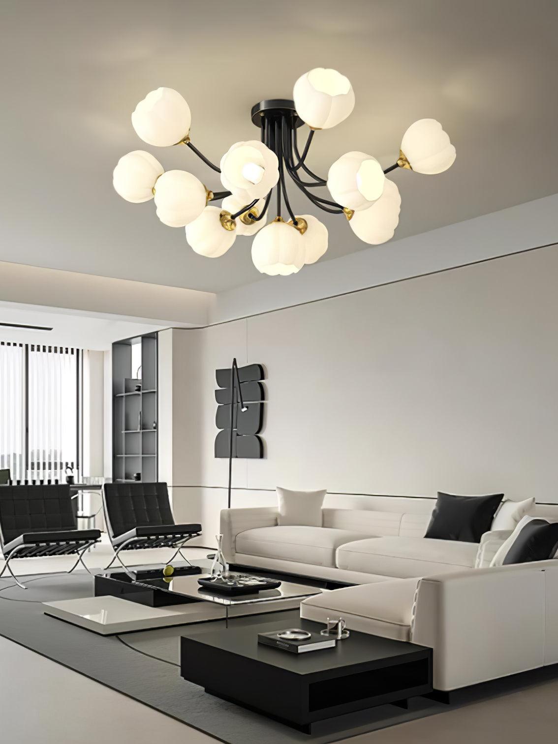 Black Pumpkin ceiling light with white lobed shades above black chairs and a glass coffee table