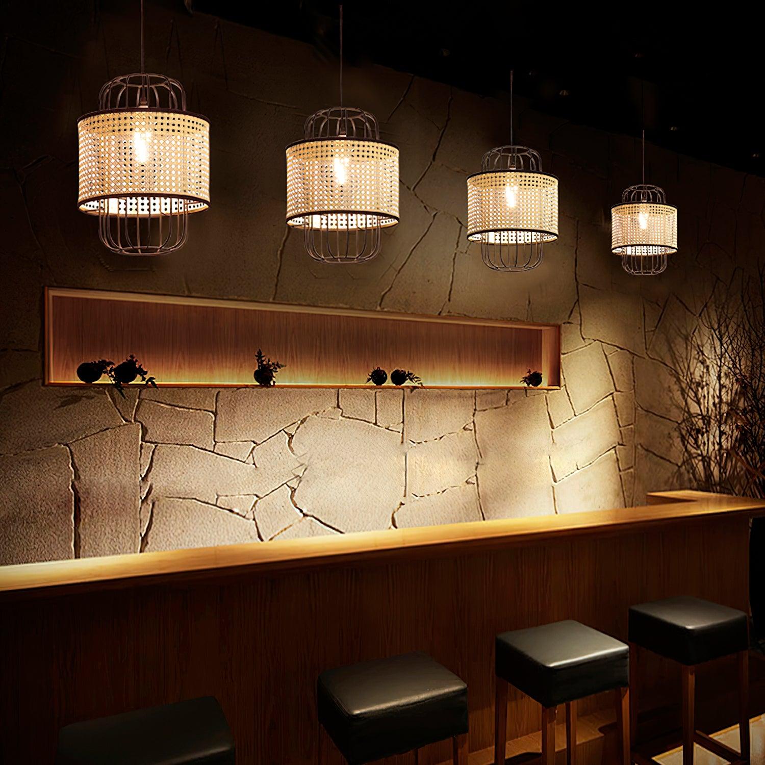 Four separately suspended rattan cage pendants above a bar with black stools