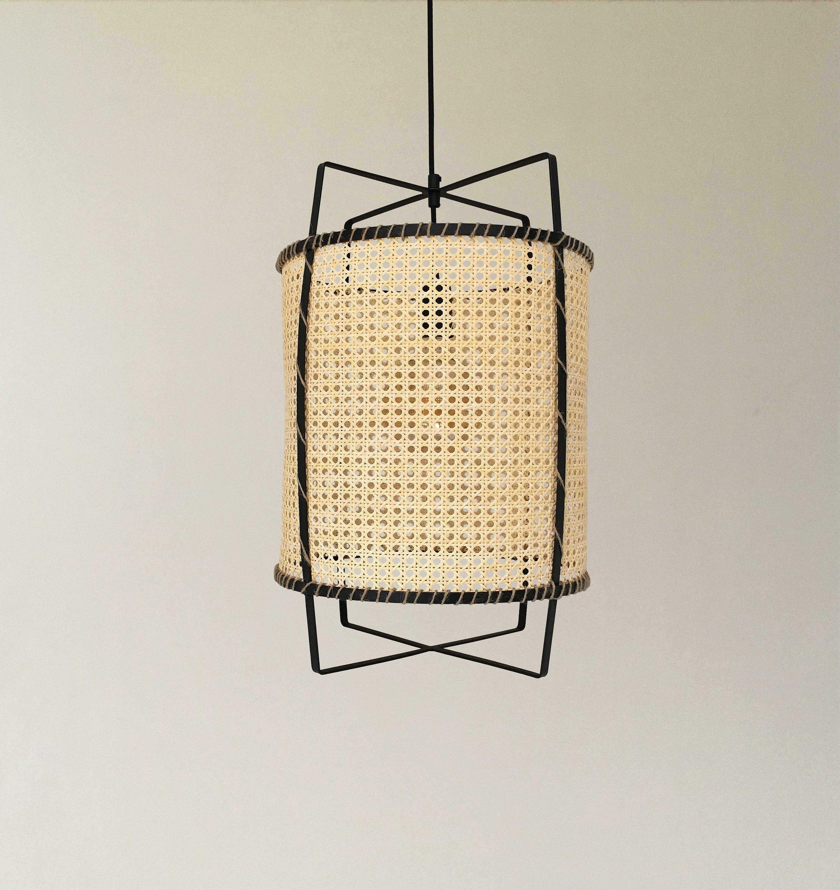 Front unlit Rattan Cane pendant with open woven cylinder and black frame extending above and below