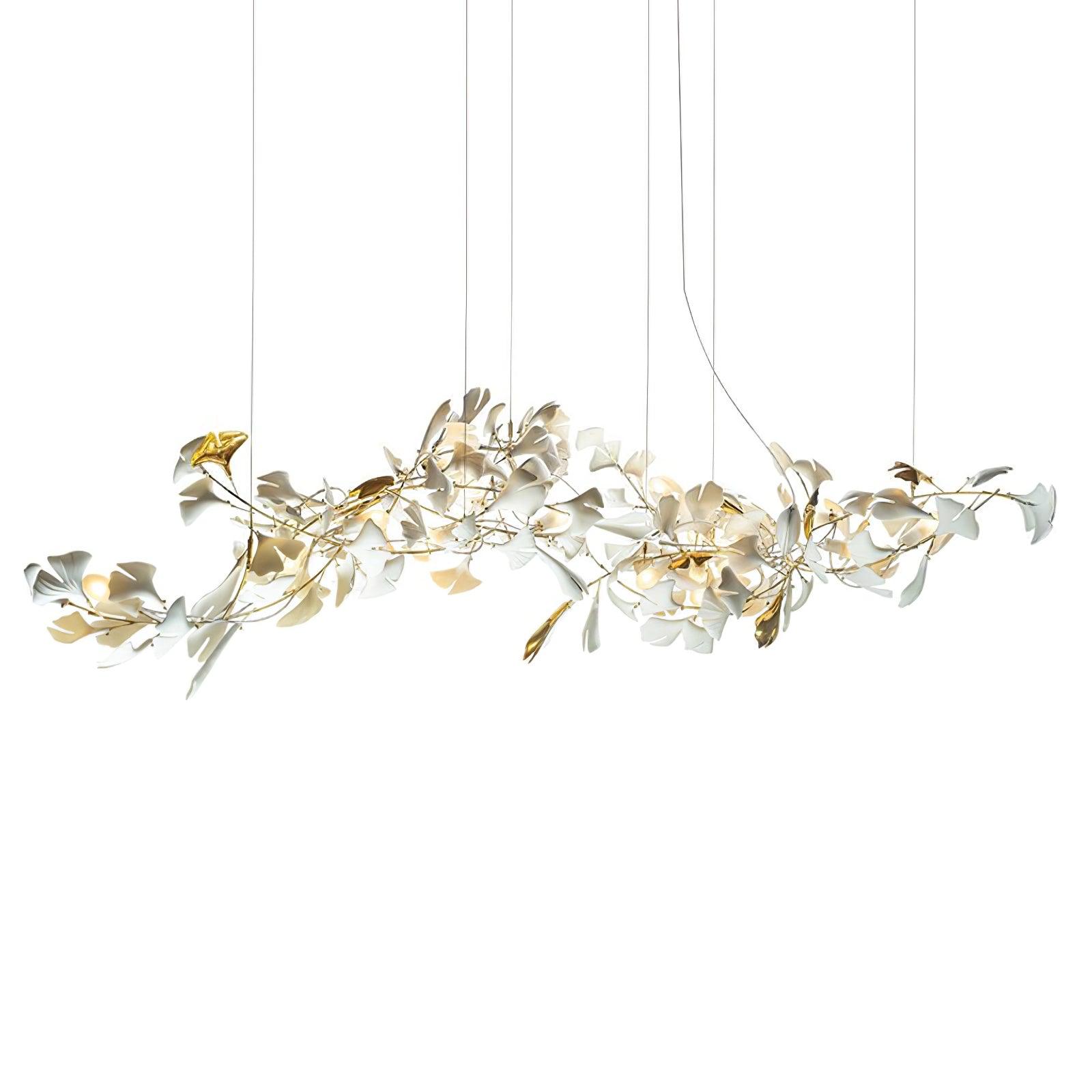 Isolated elongated gold-and-white ginkgo chandelier lit on white with cropped suspension wires