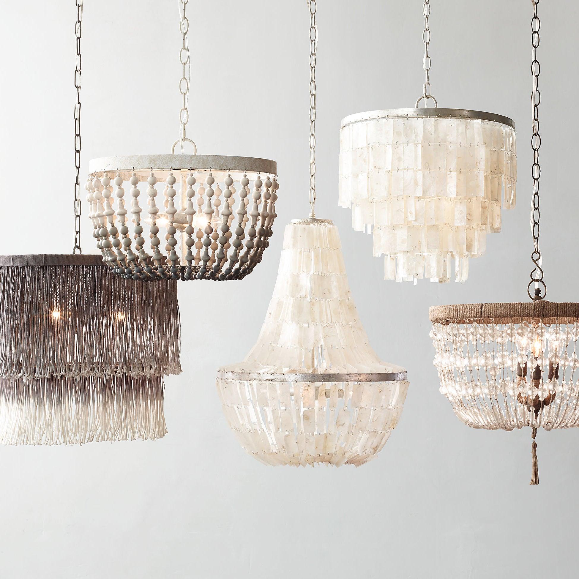 Rectangular tiered shell pendant at upper right among other pendants with different bead, strand and shell shapes
