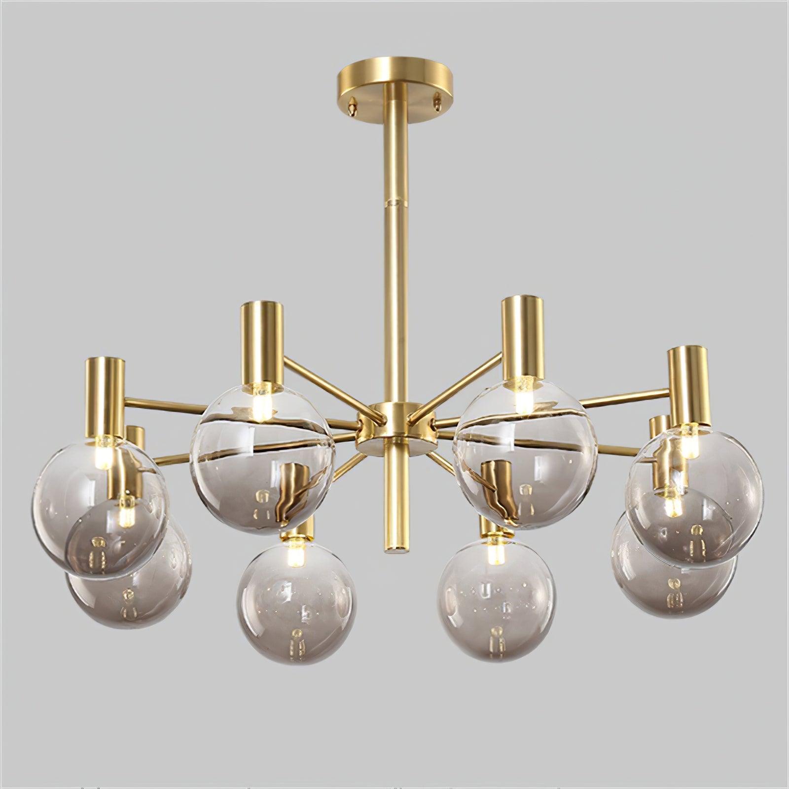 Angled close view of eight clear globes with lit capsule lamps, gold-tone holders and a round ceiling canopy.