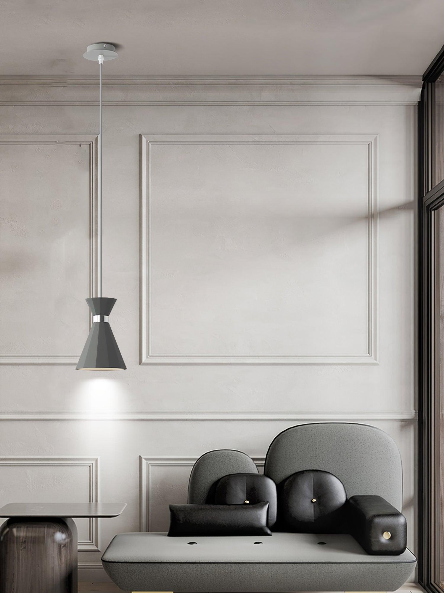 Tall grey pendant near a chair and panelled wall