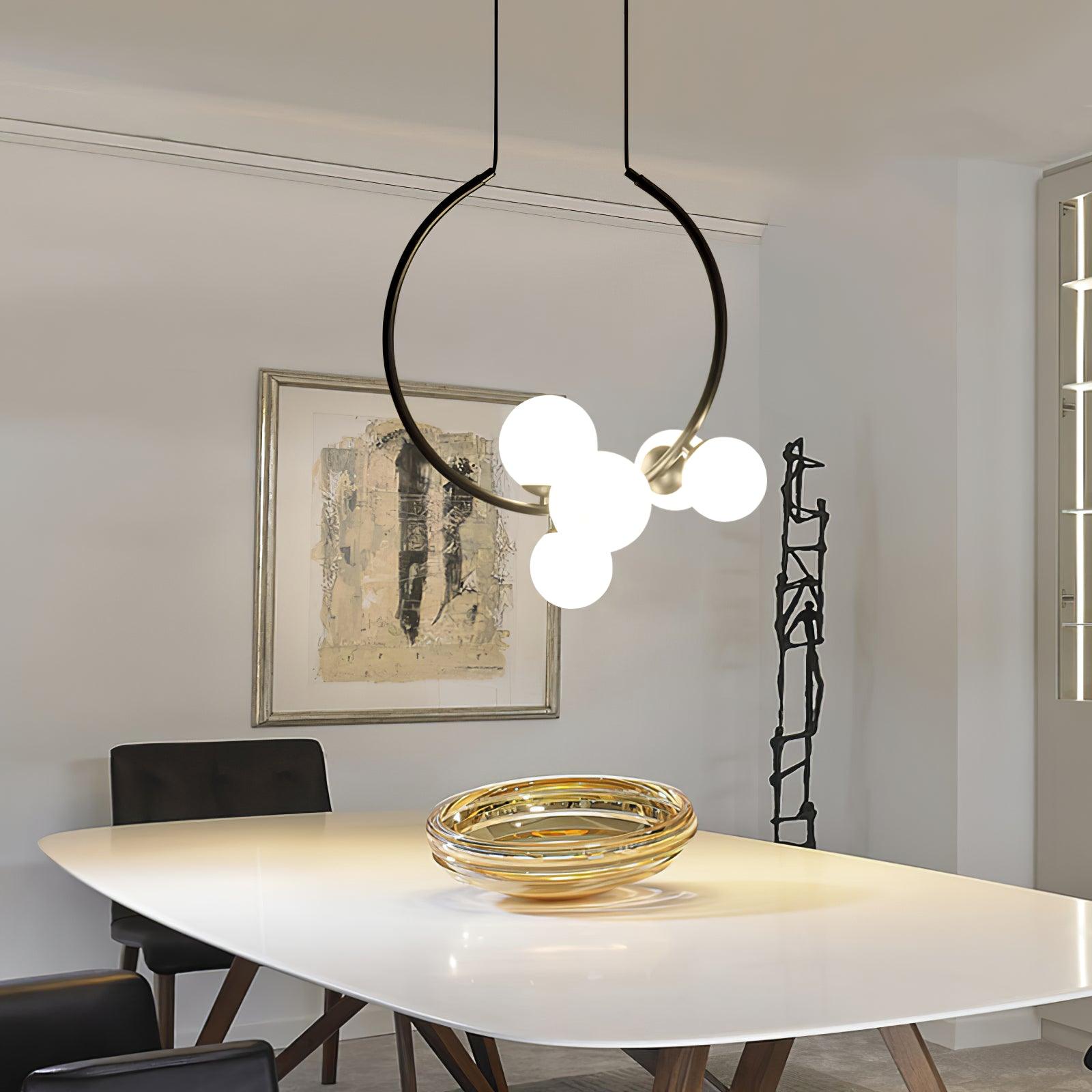 Black ring pendant above a white dining table