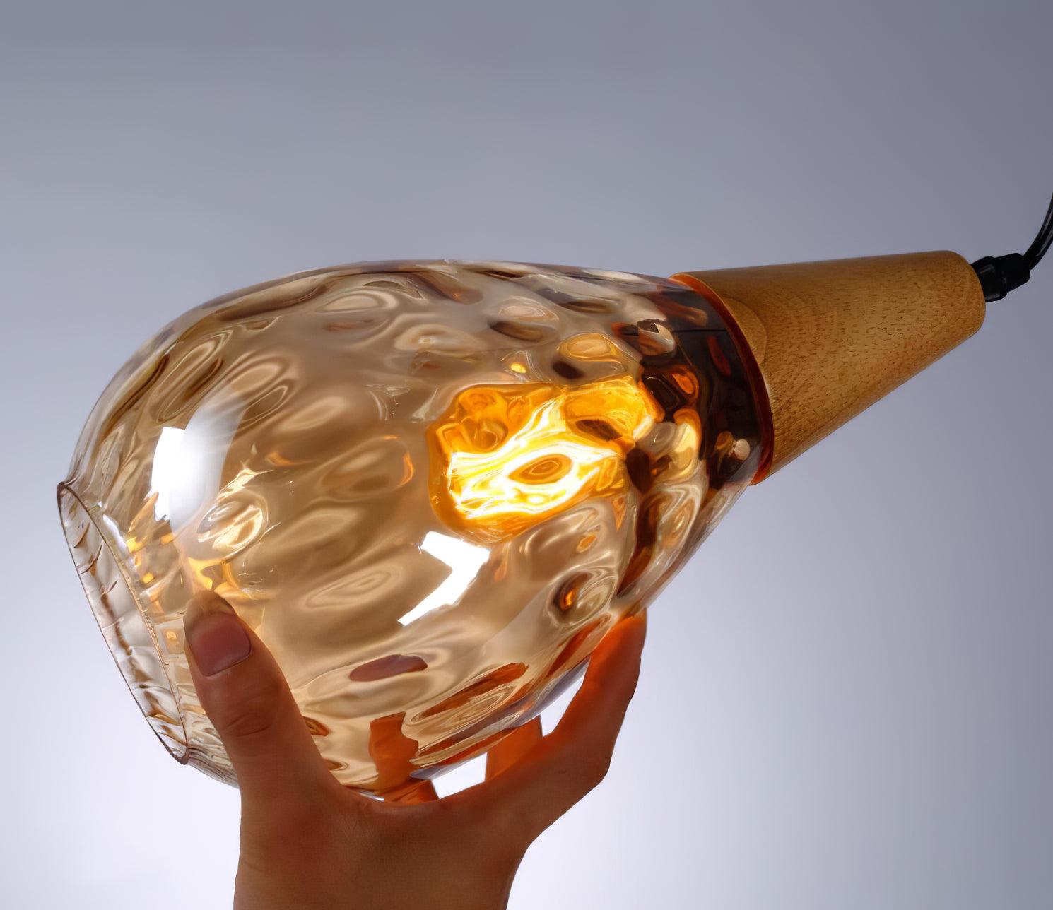 Amber glass shade showing the lit bulb through its texture