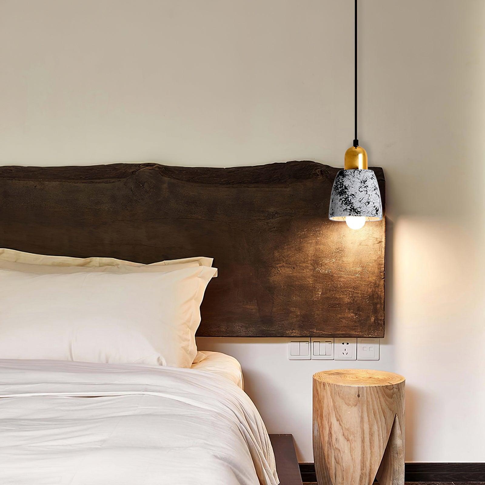 Patterned White cement pendant beside a bed