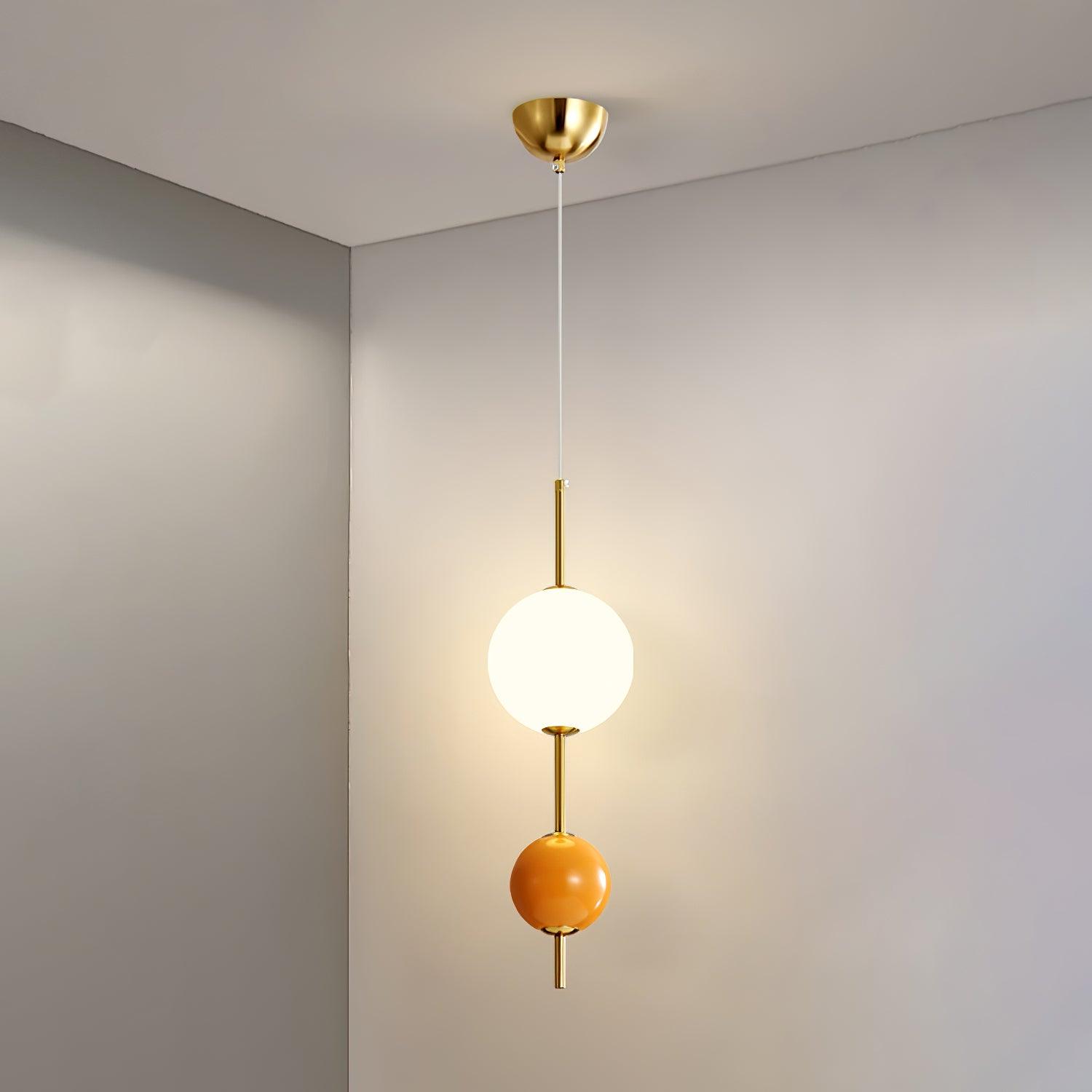 Orange two-ball pendant shown illuminated with full suspension