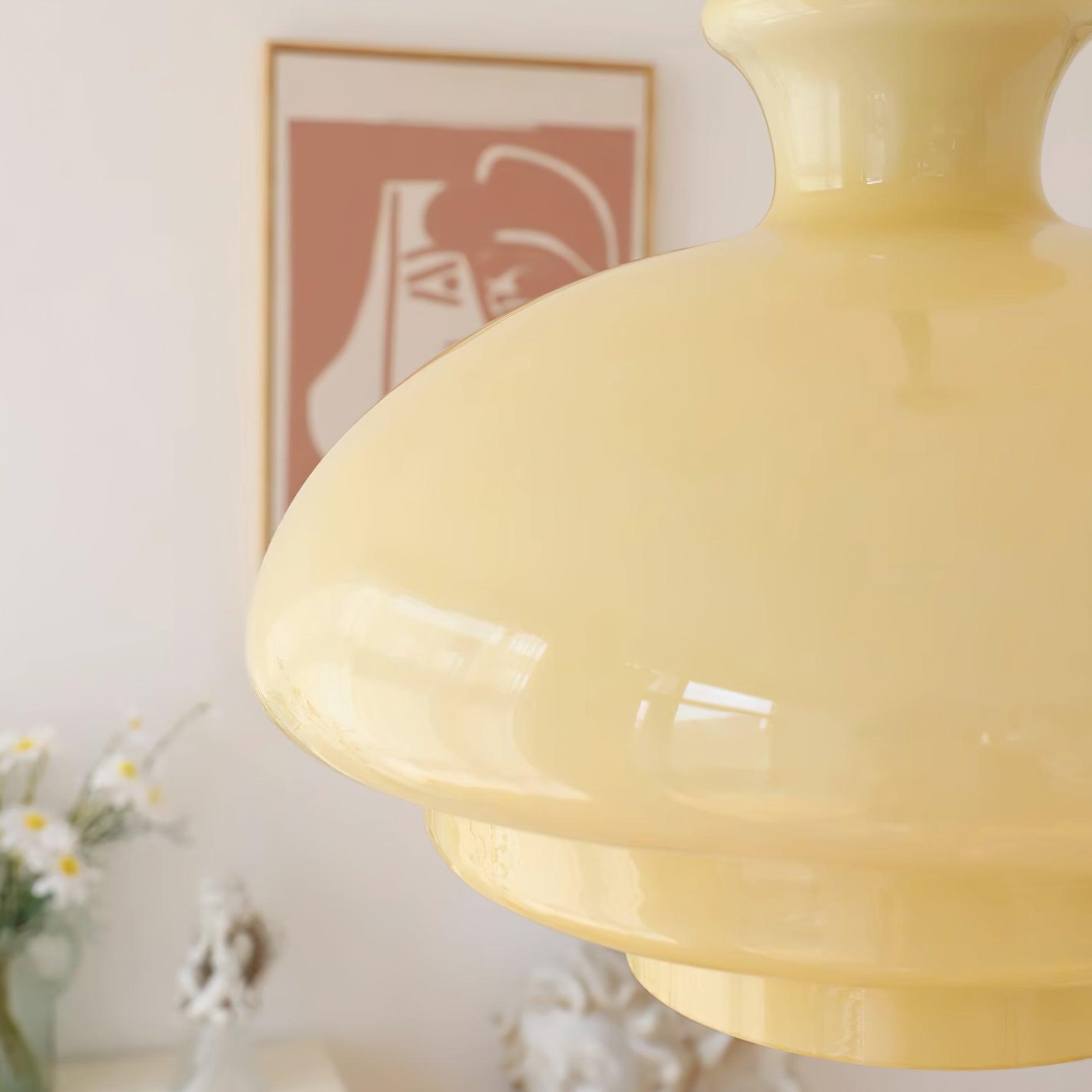Side detail of the glossy yellow dome and stepped lower edges with orange artwork and flowers behind