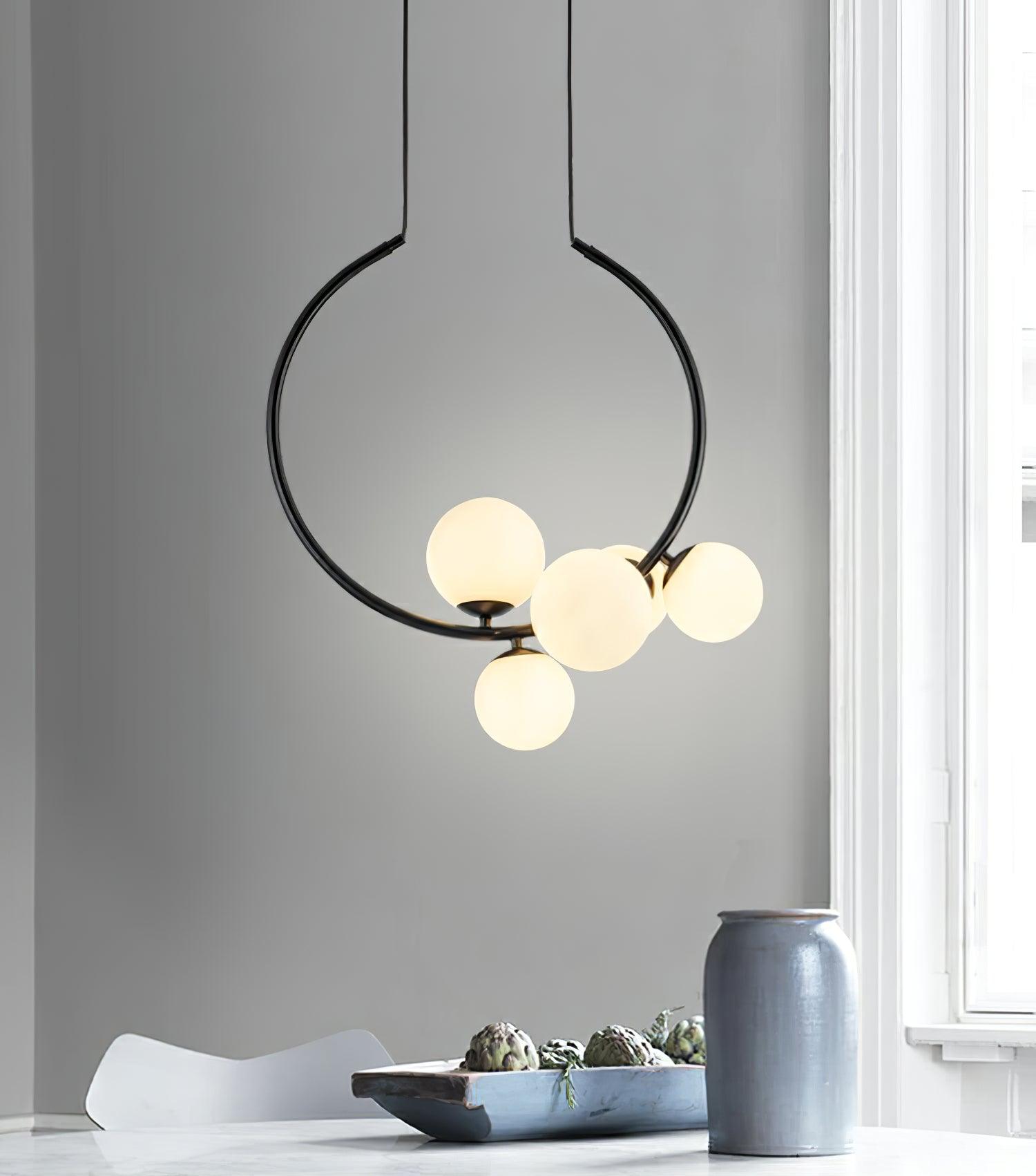 Black open-ring pendant beside a bright window
