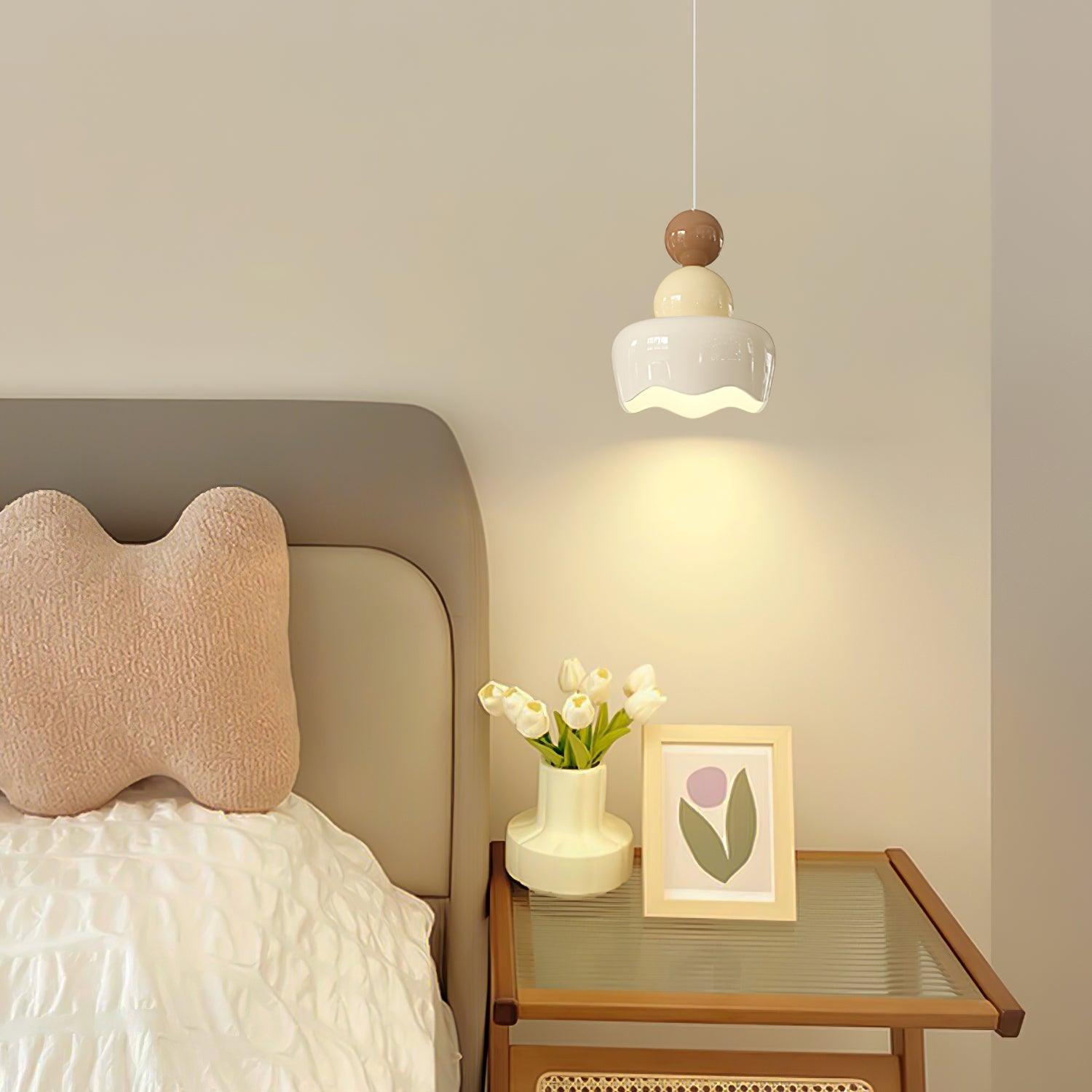 White and cream doll pendant above a nightstand