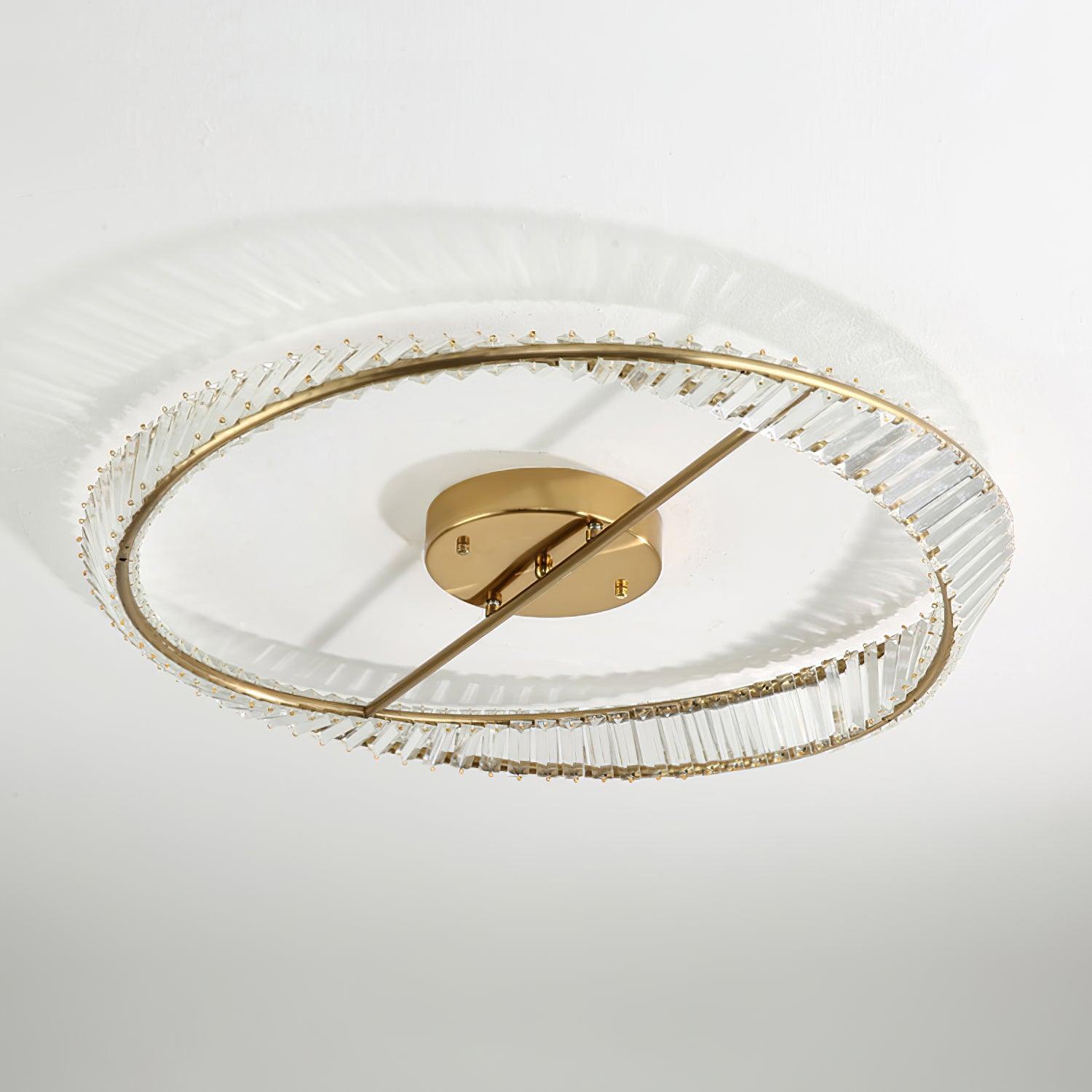 Unlit clear glass ring with a gold-tone crossbar and central round ceiling canopy