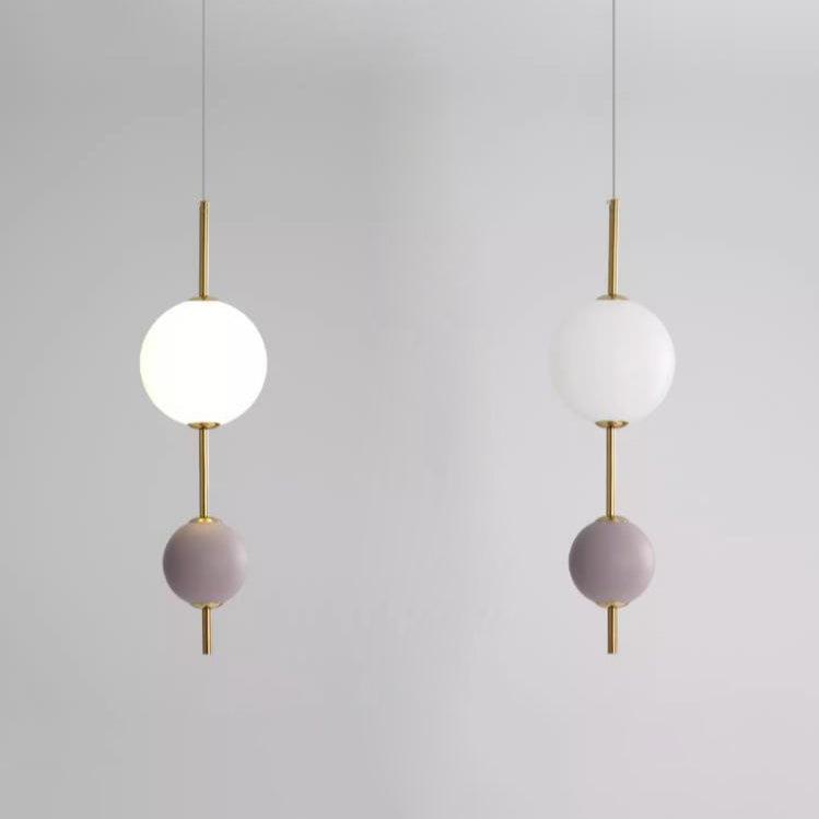 Violet two-ball pendant shown lit and unlit side by side