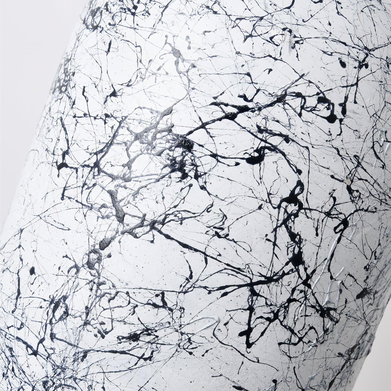 Close view of dark branching pattern on White cement shade