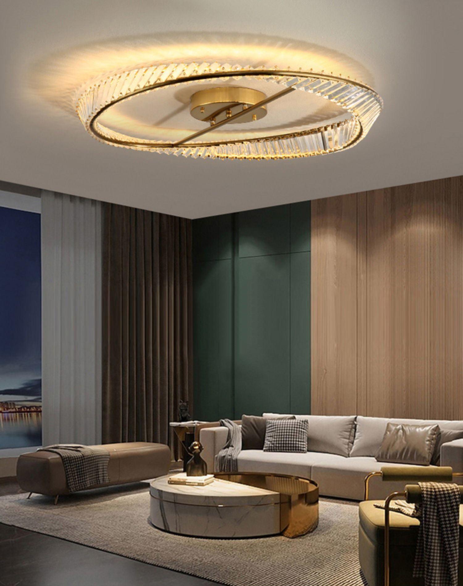 Illuminated glass ring light above a white sofa and round coffee table beside a green panelled wall