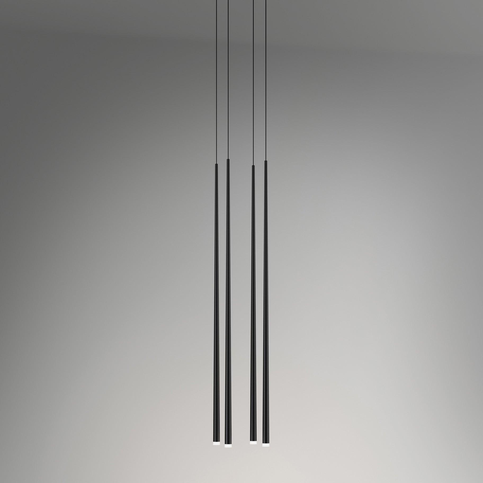 Four black tapered tubes photographed with nearly level white end caps on grey