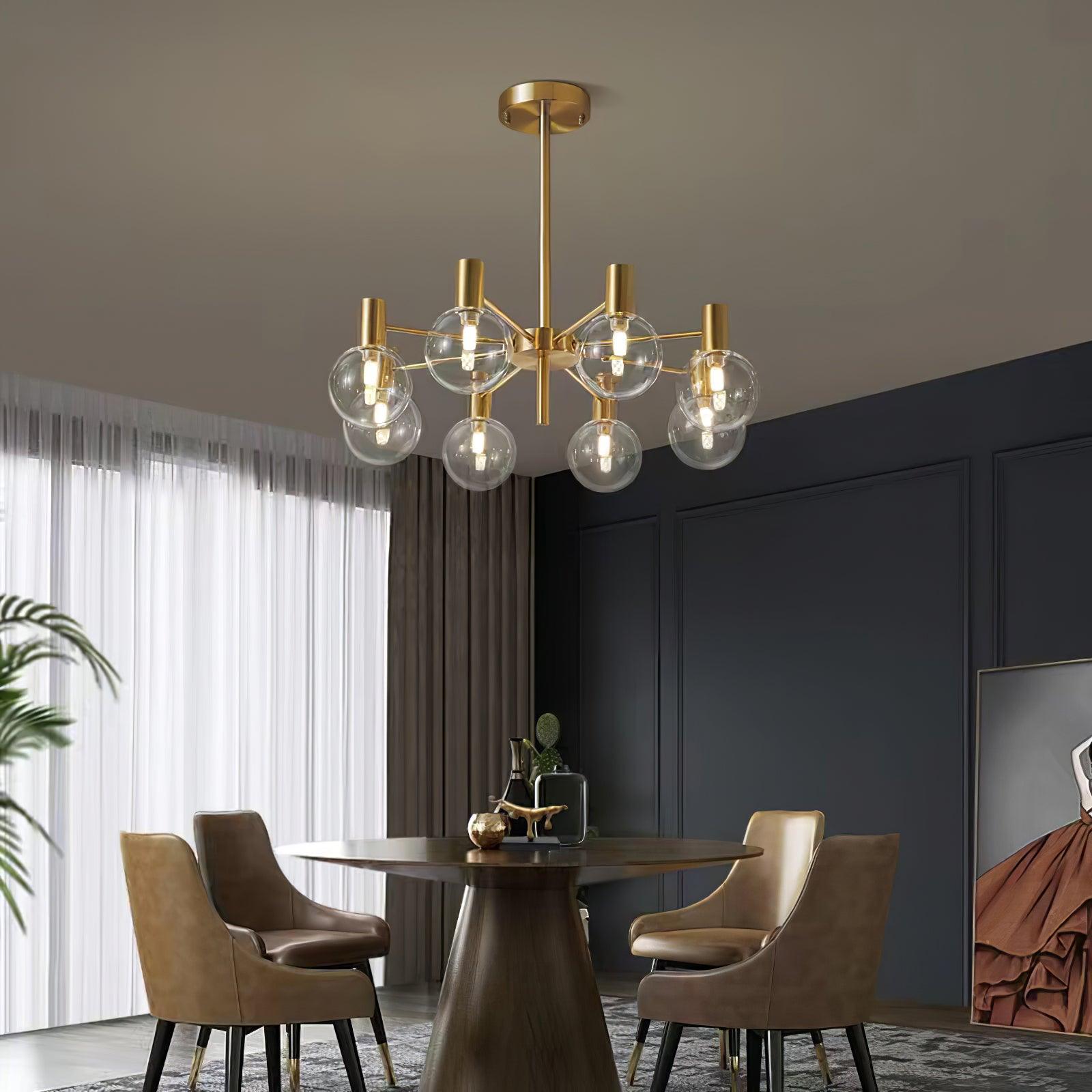 Eight-clear-globe chandelier above a dark round dining table with tan chairs, beside white sheers and a dark panelled wall.