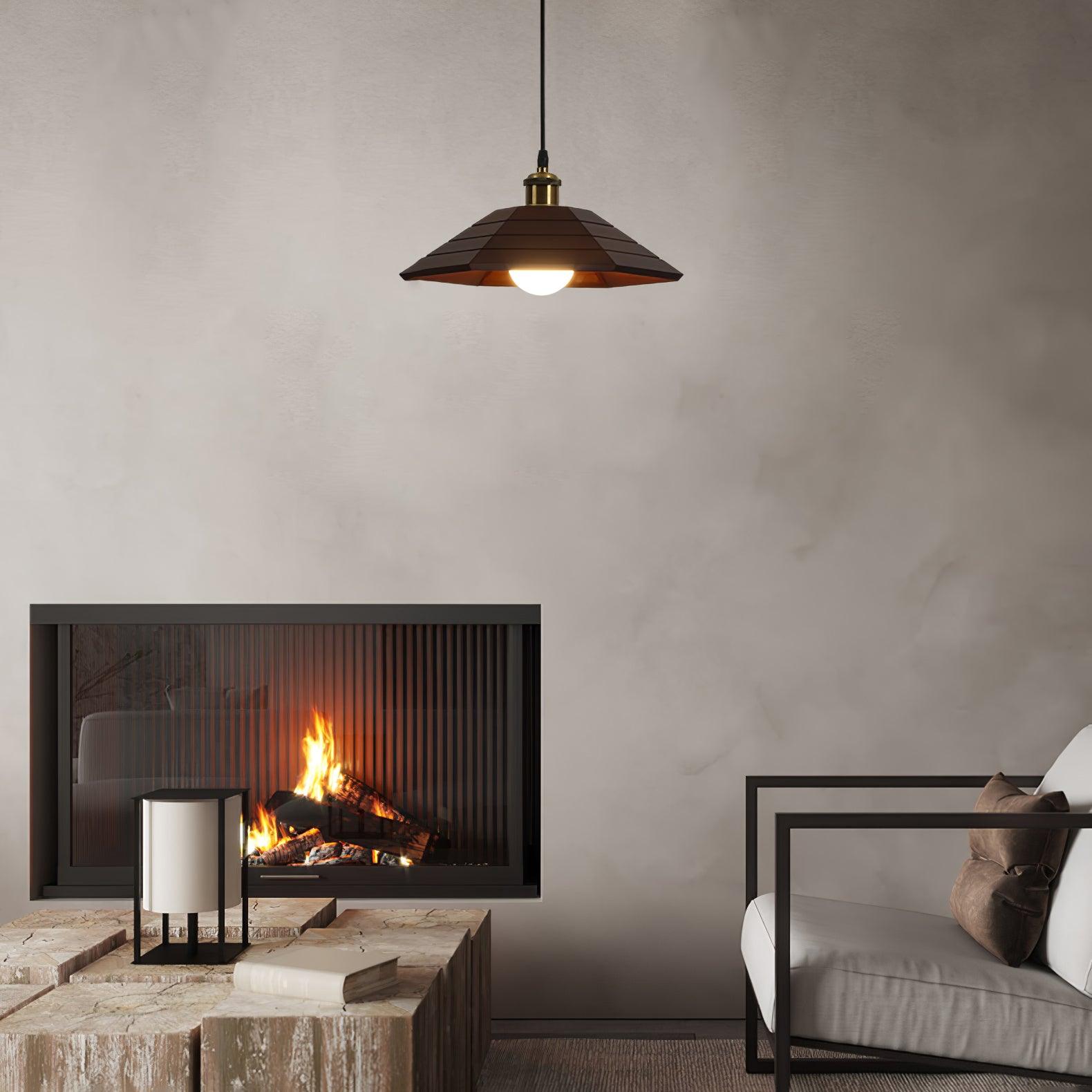 Dark wood umbrella pendant in a seating area with fireplace, stone table, books and a white cushioned chair
